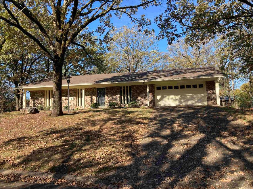 Situated on great, one block street, this mid century modern boasts lots of updates while maintaining many period features.  Family room with natural stone fireplace/ hearth opens nicely to kitchen/ dining area.  Tiled kitchen features granite counters, updated appliances, painted cabinetry, and pantry.  Extra living/ study area or game/ play room.  Spacious master suite with full bath.  New luxury vinyl plank flooring and interior paint.  Tiled baths feature granite vanity tops.  Utility room with work sink and is large enough for freezer.  Good closet space and storage thru-out including partially floored attic and garage shelving.  Large front porch, plus rear patio.  Stone/ freshly painted cedar exterior.  Replacement vinyl windows, updated roof.  Fenced, shaded backyard.  Put your landscaping skills to work in your natural rock outcropping flower bed!