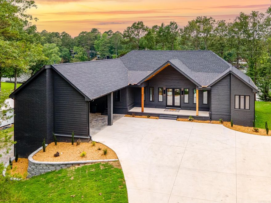 Lakefront Luxury Living at Its Finest!  Welcome to your dream lake house—a stunning, almost-new construction offering over 4,000 square feet of luxurious living space right on the water. This exceptional home features 4 spacious bedrooms, 4 full bathrooms, and 2 half baths, providing comfort and privacy for family and guests alike.  Designed for both relaxation and entertaining, the home boasts two elegant living rooms, one of which has a wet bar, games, multiple televisions, a pool table, and a dedicated 8-bed bunk room—perfect for hosting a crowd in style. Step outside and you’ll find your private lakefront oasis, complete with an inground pool and jacuzzi spa overlooking the serene waters.  Enjoy effortless lake days with your very own boat dock and slip just steps from your back door. Whether it’s morning coffee with sunrise views or sunset swims under the stars, this home offers the ultimate lakefront lifestyle.  Every detail has been thoughtfully curated to elevate your experience—this is luxury living, redefined. Don’t miss your chance to own this extraordinary waterfront retreat!