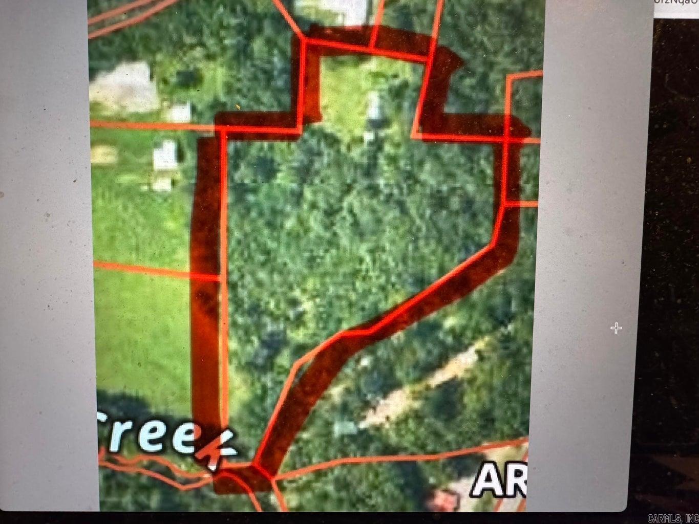 5.68 +/- acres with North Big Creek frontage. Land has city utilities available and no restrictions. Close to town and amenities and yet still secluded! There is city sewer and city water, the old house place has not been given any value.