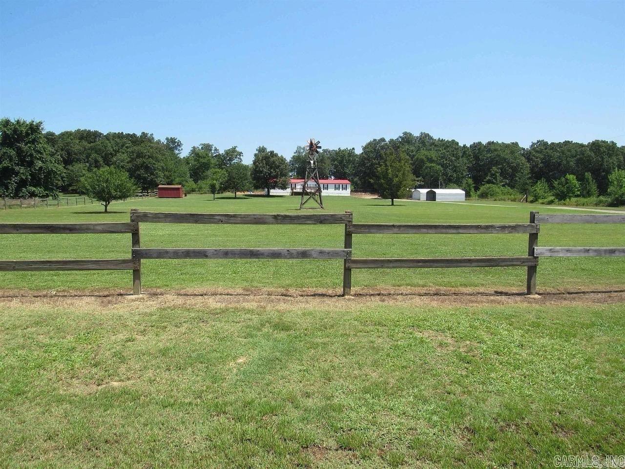 Welcome to your country retreat! Nestled on 3 beautiful acres, this spacious 4-bedroom, 2-bathroom double wide mobile home offers 2,052 square feet of comfortable living space and quiet rural living. Outside, you'll find multiple metal buildings and storage shedsāideal for a workshop or equipment and vehicle storage. There is also a storm shelter. The land is mostly open with trees and is ready for gardening, animals, or just relaxing and enjoying the country setting. This property is on a permanent foundation Whether you're looking for space to spread out or just a quiet spot to settle down, this one checks all the boxes. Schedule your showing today! Agents see remarks.
