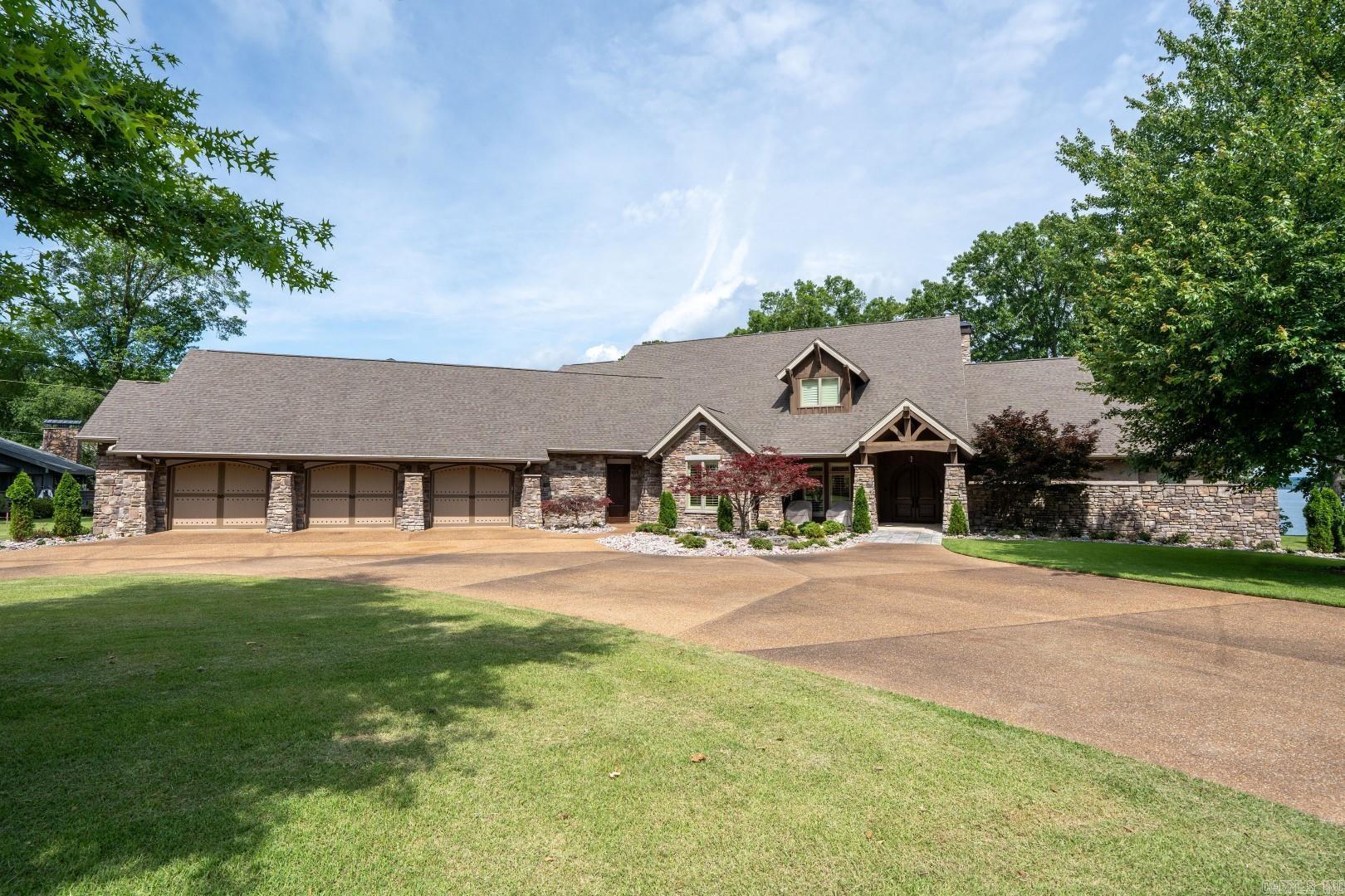 Eden Isle LAKEFRONT (completely furnished) home with about 200 feet of lake frontage and excellent lake views! This lovely home, built in 2010, sits on what used to be 3 lots that have been replatted into one large lot that totals over an acre! The main house has 3 bedrooms (all very large suites) and a half bath. Additionally, there is a 4th bedroom/living area and a 4th full bath! The 3-car garage is huge and could be additional living space...it's eat-off-the-floor clean! Very tall cathedral ceilings in the open kitchen/living/dining areas, dry-stack stone fireplace, wall of glass looking over Greers Ferry Lake, 2 dining areas, wet bar, his and hers master bathroom suite, manicured lawn and landscaping, ample parking...simply a beautiful setting for one of the highest quality homes on Eden Isle!