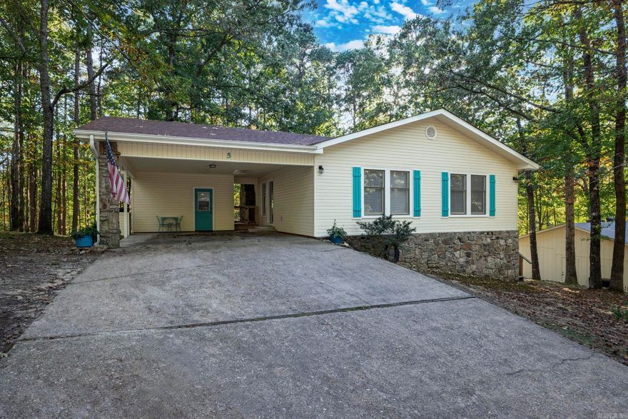 This home is truly move in ready. Updates include, new architectural shingle roof in 2024, new lvp flooring throughtout, new marble look waterproof flooring in both baths', new countertops in both baths', new sinks and toilets in both baths', kitchen remodeled with new countertops and new electric range, all new interior and exterior doors, complete interior paint, all new ceiling fans, linear electric fire place, new and enlarged back deck, new concrete and wood walkway at back deck. Large storage or workshop in crawl space. Double carport with storage room, back yard is fenced with black chain link. Common property to the rear. This is NOT a flip house. Quality work done on all improvements. Sunroom is not included in square feet.