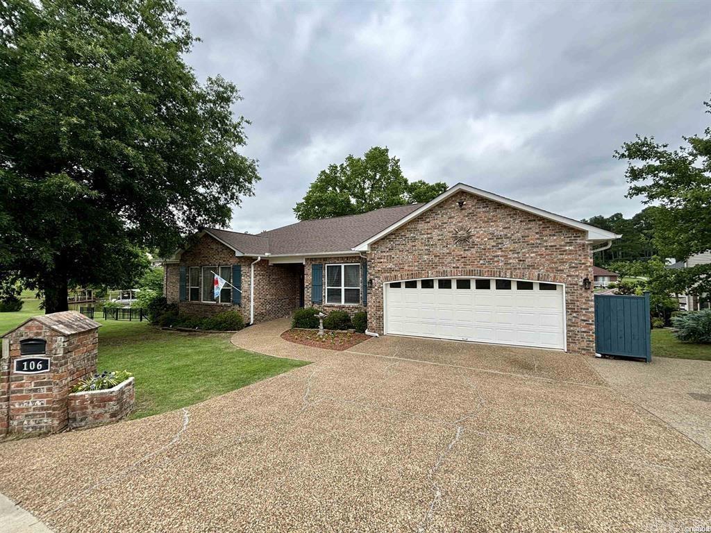 BRAND NEW ROOF! This spacious, well-appointed Lake Hamilton property boasts an impressive array of features. Would make an awesome STR! With 5 bedrooms and 3.5 bathrooms, it offers ample space for families and guests. The prime lakefront location includes a covered boat dock and room for a second boat. Indoors, a cozy living room with a gas log fireplace and high ceilings sets a welcoming tone. An open layout seamlessly connects the living room to the kitchen and dining area, complete with a convenient serving bar. The kitchen is a highlight with beautiful cabinetry, s/s appliances, a double oven, and a pantry. This home has a formal dining room, ideal for entertaining. A covered deck provides a relaxing outdoor space with stunning lake views. The main floor's master bedroom features a fully renovated en suite bathroom with double sinks, a makeup vanity, a tile shower, a jetted soaker tub, and a walk-in closet. The lower level accommodates guests or extended family with two bedrooms, an office, a living room, and a full kitchen. A workshop with a full garage door offers easy backyard access. A walkout from this level leads to a covered patio overlooking the lake. Welcome HOME!!