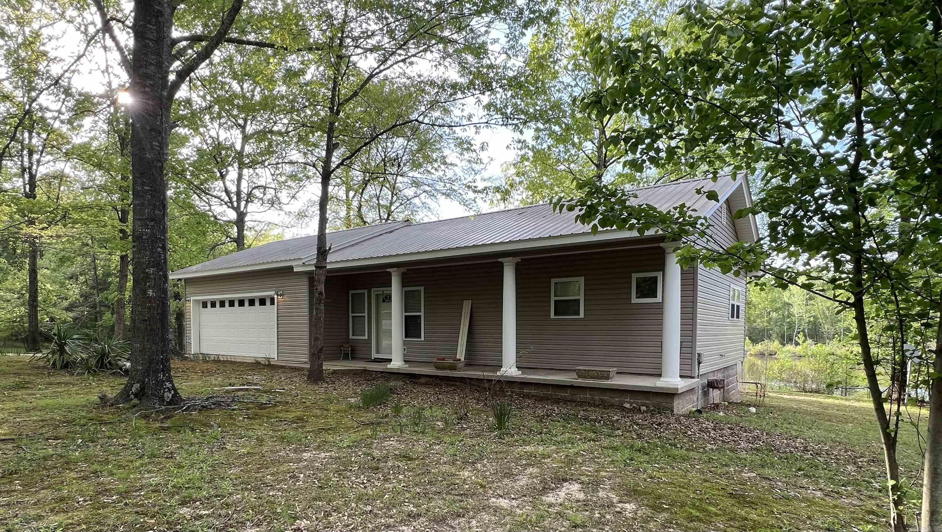 Nestled just minutes from both Henderson State University and Ouachita Baptist University, this 34-acre property offers a perfect blend of convenience and natural serenity. The well-kept 1-bedroom, 1-bathroom home sits on a gentle rise overlooking a beautiful 3-acre stocked pondāideal for peaceful mornings or relaxing evenings on the back deck. Designed with an open floor plan, the home feels spacious and inviting, with scenic views that bring the outdoors in. A portion of the garage has been thoughtfully converted into a large storage room, providing extra functionality without sacrificing space. The land itself is mostly wooded with level terrain, offering endless potentialāfrom expanding the existing home to developing additional structures further back on the property. Whether you're looking to downsize, invest, or build your dream retreat, this property is a unique find in a highly desirable area.