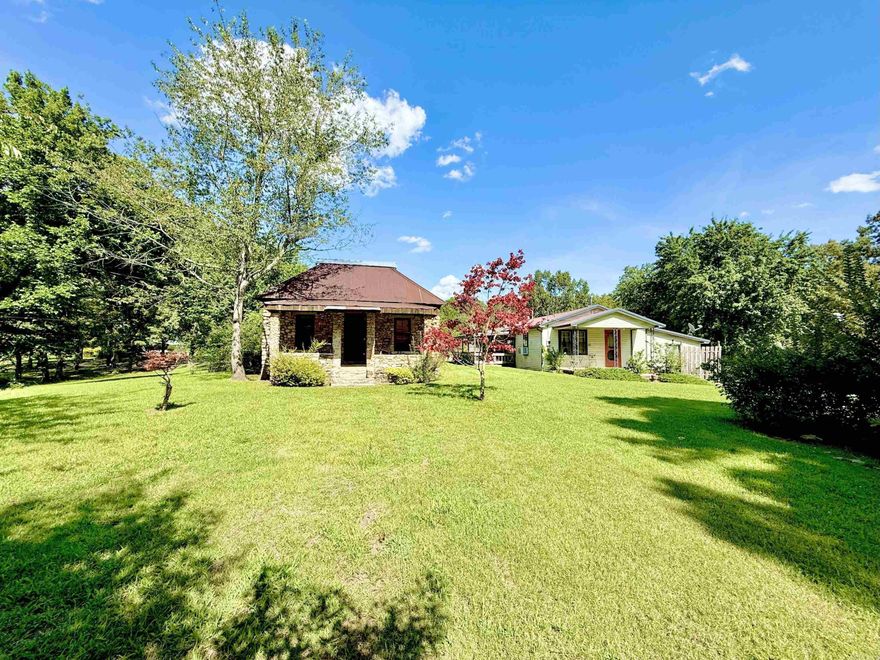 This one acre property is located less than 3 miles from the Calico Rock boat dock on the White River, a premier trout fishing destination.  Step into a piece of history in this charming stone  dating back to 1921! The 1,248 sq ft main house features a large bedroom, a smaller second bedroom or office, a spacious eat-in kitchen with bay window, and a retro free-standing gas stove, blending vintage charm with everyday comforts. Original wood ceilings, vintage glasswork, and a clawfoot tub add unique character. A quaint living space, with a dining area and study give it old-school charm. The second home on the property includes a large kitchen, cozy living room with wood stove, two bedrooms, and a recently updated bathroom. Both homes feature inviting patios - perfect for soaking in the natural beauty of the Ozarks. The property is completed with a barnwood shed that has plenty of Ozark charm! Adjacent 1 acre property with a large shop and commercial potential also available!