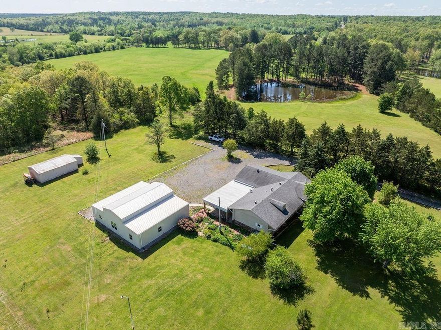 Lovely "Triple Wide" on almost 10 acres with a stocked pond.  This home has 3 bedrooms with built in drawers and locker closets.  Big windows highlight the spacious yard and let in a generous amount of natural light.  The master has a re-designed shower for "step in" ease and comfort. A well appointed kitchen includes all appliances.  The large living room boasts a vaulted ceiling! There's an additional shop building that is 75% complete as being turned into a wonderful and LARGE living space!  Sale includes a 2015 Bad Boy 60" zero turn mower!  A must see.