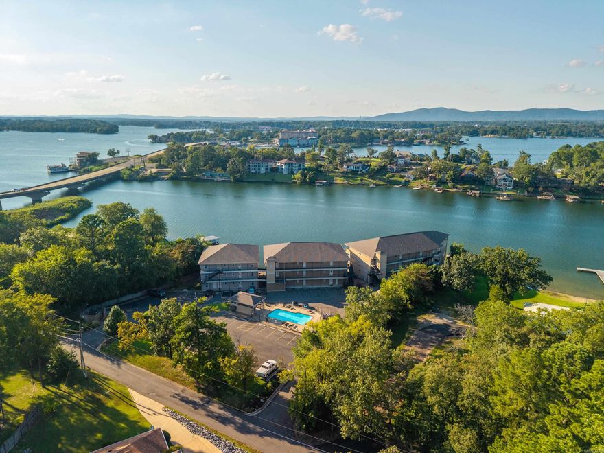 ~Turnkey. Waterfront. Income-ready.~ Built in 2020, this ground-level Lake Hamilton waterfront condo offers a rare opportunity to own a fully furnished, turnkey retreat in one of the most desirable areas of Hot Springs. Located just outside city limits-no short-term rental permits required-it’s perfectly positioned for both personal enjoyment and income potential. Set along the main channel in the coveted Highway 7 South corridor, you’re only minutes from the best dining, shopping, and entertainment. Inside, natural light pours in while the great room and primary suite frame stunning lake views. Step onto the balcony and take in expansive 180-degree vistas - your front-row seat to lake life. Everything has been thoughtfully curated, with furnishings and appliances all purchased within the last three years. The community boardwalk has been recently rebuilt, and the convenience continues with an assigned parking space just steps from your front door. This is where effortless lake living meets smart investment-ready the moment you arrive.