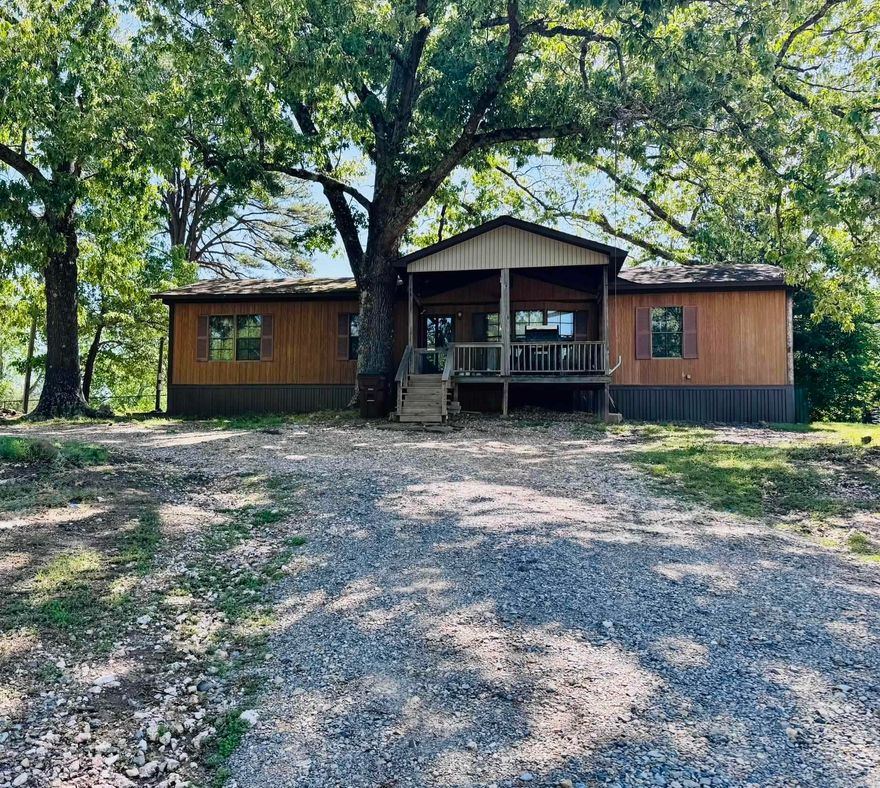 Love that small town living feel, but still want to be close to the largest lake in Arkansas? Come take a look at this double-wide on almost an acre inside the city limits of Mount Ida. This home features 3 bedrooms, 2 baths, with primary room having a walk-in shower and a very large walk-in closet. New flooring throughout the home, new HVAC system, and a covered front porch that overlooks the mountains out front.