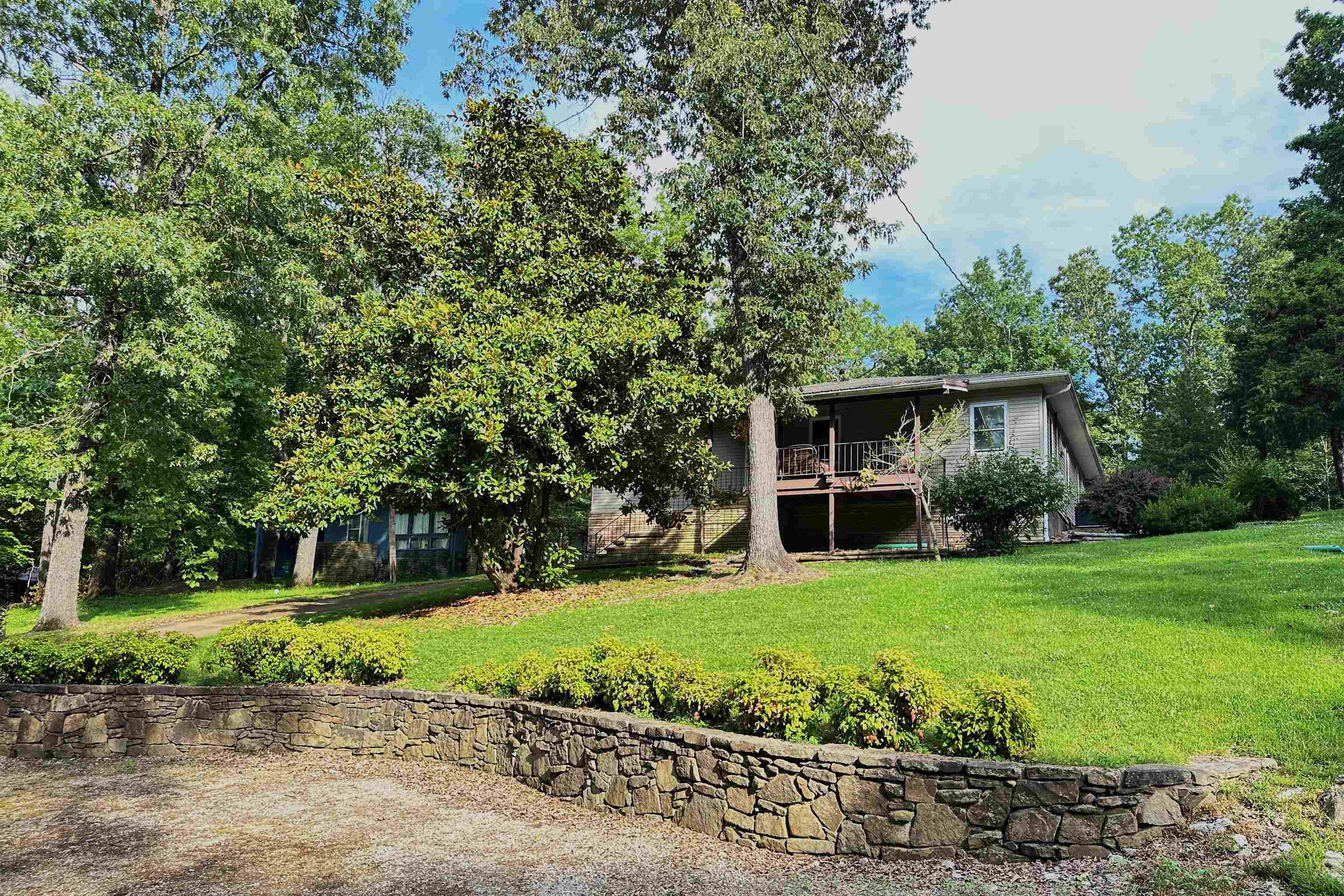 Charming, move in ready, and clean as a whistle! This well cared 2 bed/2.5 bath on 3/4 of an acre home is a retreat inside and out. Large windows throughout allow beautiful views of nature and natural light all year round. Our beautiful Cherokee Village offers 7 lakes, 2 golf courses, hiking trails, and much more tucked in the Ozarks. This home is perfectly situated to enjoy all of these, but perfectly appointed to enjoy staying home, too! Features include a lovely kitchen with lots of storage and counter space including a breakfast bar and is open to the dining and living rooms. The living room has a picture window over looking the tree tops and a beautiful fireplace and dedicated office area. Both bedrooms have private baths. For those times when you want to retreat from it all...look no further than the primary suite and ensuite with such great space you may just spend the day there! Don't forget to ooh and ahh over the primary closet, too! With 1911 square feet inside, porches in front and back, 3/4 acre yard to love you'll have plenty of elbow room here. Did you see all of the extra parking and even the RV parking? Don't wait!