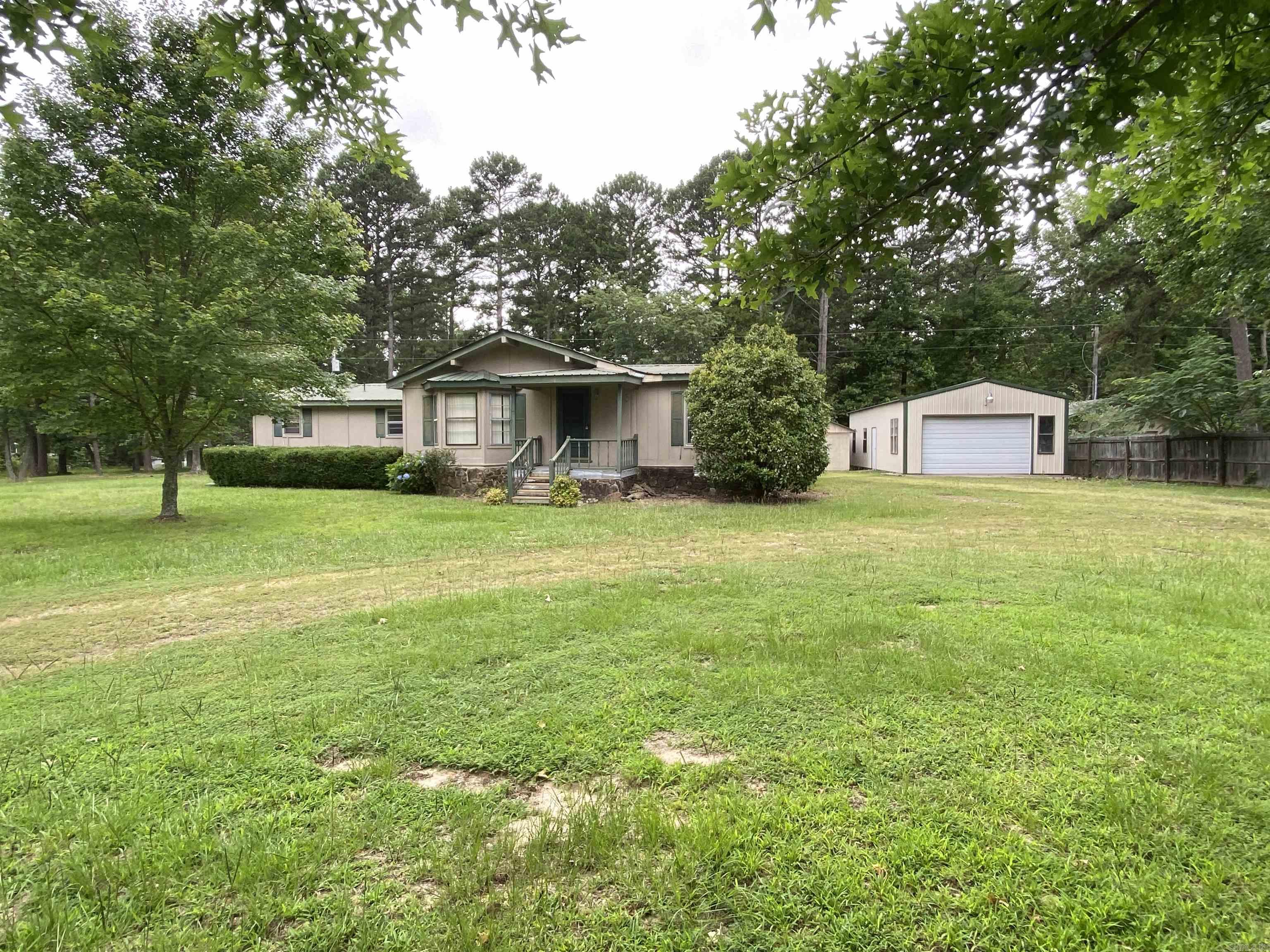 Located in the middle of town, just over a half acre. This property provides a home in need of flooring and some TLC. This home includes a screened in back deck, a nice 20 x 40 shop for lake toys, yard equipment etc. It's in a nice subdivision and quiet neighborhood. The home is a built around mobile. Would make great full time or weekender. Has mineral rights that do convey. Drive by and give us a call today.