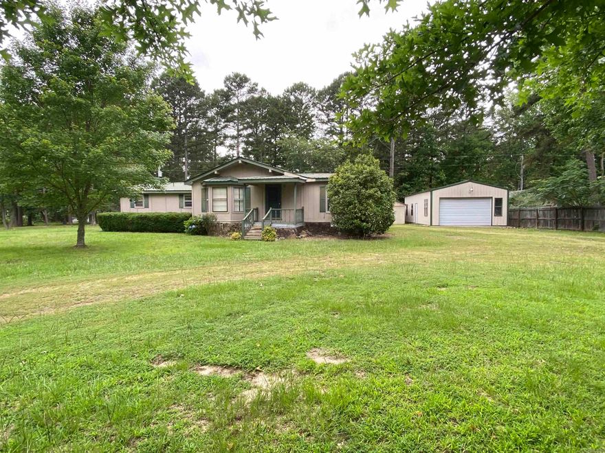 Located in the middle of town, just over a half acre. This property provides a home in need of flooring and some TLC. This home includes a screened in back deck, a nice  20 x 40 shop for lake toys, yard equipment etc. It's in a nice subdivision and quiet neighborhood. The home is a built around mobile.  Would make great full time or weekender. Has mineral rights that do convey.  Drive by and give us a call today.