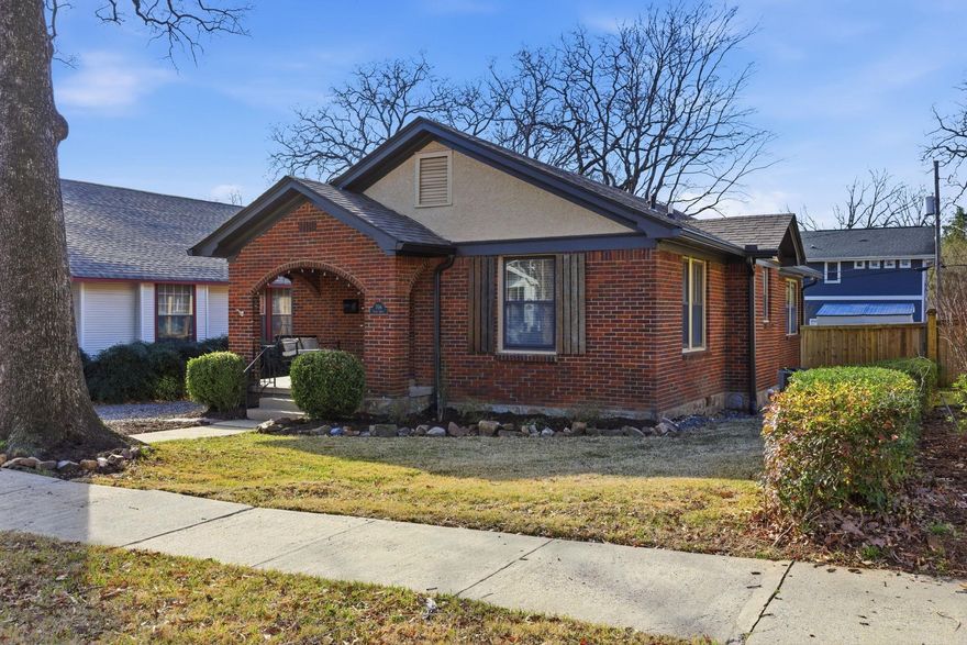 Step inside this beautifully renovated Hillcrest bungalow blending historic charm with extensive modern upgrades. Refinished original oak floors and a comfortable floor plan create a warm welcome from the moment you step in. The standout kitchen, with solid stone countertops, stainless steel appliances, and a gas range, opens to a dining area featuring custom cushioned banquette seating with built-in storage. Both bathrooms are fully renovated and the primary suite includes a walk-in closet. A dedicated laundry/mudroom addition adds everyday functionality and storage without sacrificing character. Outdoor living shines with a two-level deck overlooking a fenced backyard with alley access, a double-door gate, and future potential for a carport or garage. Freshly sodded and leveled in 2025, the back lawn offers a turnkey space for entertaining, pets, or play. Smart upgrades include a tankless water heater, French drains to the alley, oversized gutters with mesh, and a storage shed that conveys. Window treatments, washer/dryer, and dining table all convey—adding immediate value and ease. Historic tax credit approved. Located just steps from Hillcrest’s shopping and dining!