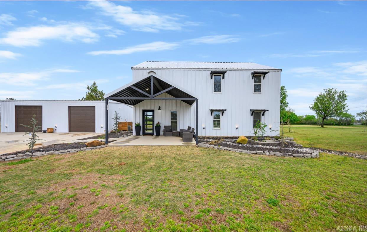 Custom built in 2023, this contemporary home offers all the bells and whistles: Two story home offers a spacious living space, separate shop building w/full bath, separate hot water and CH/CA, covered patio with gas fireplace, hot tub and outdoor shower, fire-pit, pickleball/basketball court and putting greens. Home offers open concept: living room with electric fireplace and vaulted ceiling, kitchen offers large island/bar, gas stove, dishwasher, built in microwave and refrigerator. Master suite downstairs with master bath, two additional bedrooms and two full bathrooms upstairs. Guest half bath, large laundry room, on demand hot water, EV charger, and commercial LED string lighting. A must see! Contact our office for more details.
