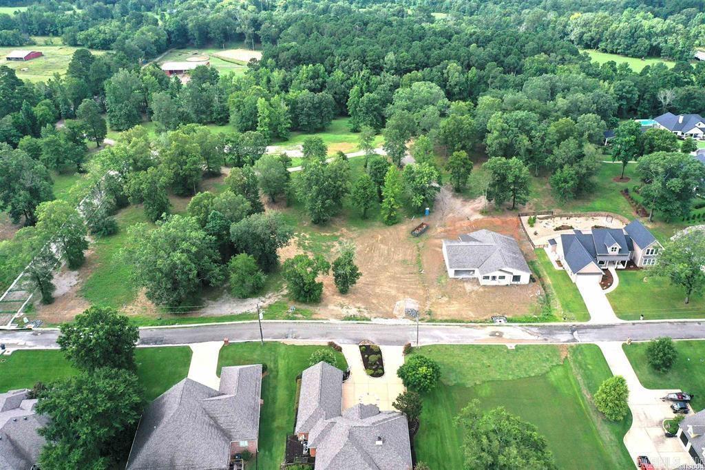 Discover a rare opportunity to own a prime building lot nestled in an exclusive gated subdivision just moments from the enchanting Garvan Woodland Gardens. This generously sized parcel offers the perfect blend of natural serenity and modern convenience. Lake Access Park: Enjoy private access to a well-maintained lakefront park on shimmering Lake Hamiltonāideal for picnics, kayaking, or sunset strolls. Modern Infrastructure: Equipped with all utilitiesāwater, sewer, electricity, and moreāready for your custom home to rise without delay. Pristine Roadways: Freshly paved blacktop streets with elegant curb and gutter design throughout the community. Stunning Vistas: Elevated views of Lake Hamilton offer a picturesque backdrop for daily living and entertaining. Whether you're looking to build a year-round residence or a weekend getaway, this tranquil lot provides a harmonious balance of privacy, nature, and accessibility.