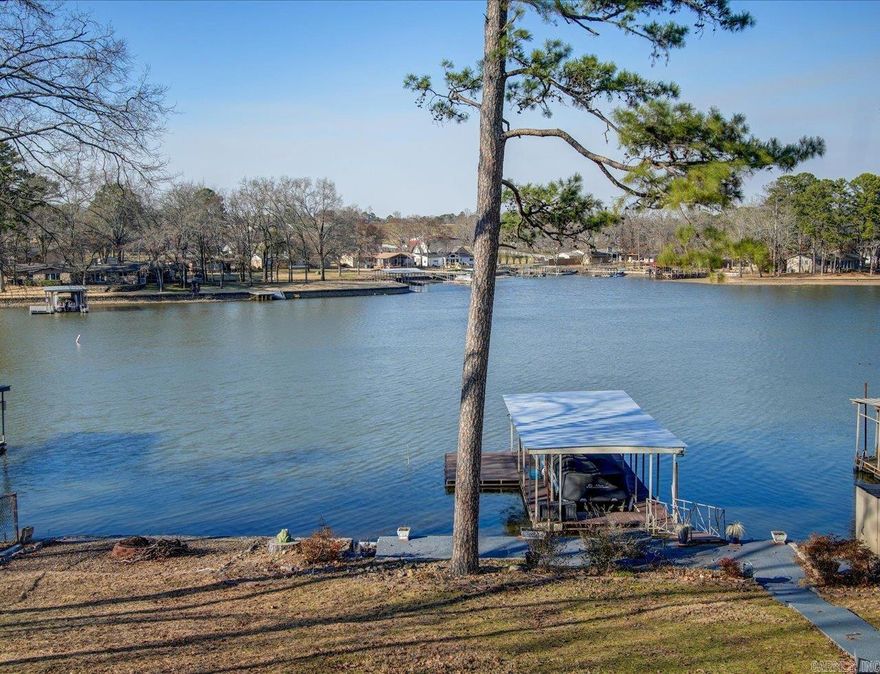 Nestled at the end of the street, this lovely lake home offers plenty of space to entertain indoors and out! Enjoy year round water from your single stall covered boat dock with swim platform. This home boasts a newly remodeled kitchen and primary bath with a spacious primary bedroom. Main living area is roomy and includes a wood burning fireplace for those chilly days and nights of winter. Then on the fall and spring evenings you can enjoy the fire pit down by the water. Downstairs offers many options with a wet bar and bar fridge. One bedroom and full bath downstairs. Three bed and two full baths walk in level. Make this your primary residence or your weekend get away! Outside city limits with no restrictions on short term rentals. Call your favorite agent today to schedule an appointment to see this beautiful lake front home that won't last long!!