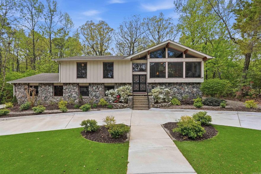 Welcome home to a beautifully renovated two-level home with classic design, function, and outdoor living. The main level offers a vaulted great room with wood beams, fireplace and built-in cabinets, formal dining room, and a fully renovated kitchen with custom cabinetry, quartz countertops, JennAir gas range w/ vent hood, KitchenAid double convection ovens, microwave, and designer details throughout. The primary bedroom suite features a spa bath with soaking tub, steam shower, dual vanities, walk-in closet, and laundry chute. Two additional bedrooms and a full bath are also on the main level. Downstairs features a spacious den with stone fireplace, wet bar with ice machine and beverage fridge, guest bedroom and bath, craft/workout room, laundry area, and extra storage. Outdoor features include a screened porch added in 2024, waterproofed deck with gas hookup, concrete patio, fenced yard, and low-maintenance turf installed in 2024. Additional amenities include a 2-car garage, 2-car carport, fresh exterior paint, new Pella windows on the rear of the home, high efficiency heating and air, surround sound, and convenient access to the neighborhood pool, park, playground, and trails.