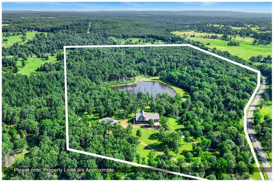 Welcome to your own private retreat! This custom-built, stunning 4BR, 3.5BA home sits on 28.5 peaceful acres and offers 3,704 sq ft of thoughtfully designed space. Features include an office with built-ins, two spacious living areas, abundant storage, a large laundry/mudroom, and an oversized garage with a safe room. The main-level primary suite includes access to a private covered deck and a spa-style bathroom with a freestanding tub, tiled walk-in shower, custom cabinetry, and a large built-in closet. Upstairs are two oversized bedrooms, each with a full bath and multiple closets—plus a central second living area and a laundry chute. The open-concept kitchen/living area features vaulted ceilings, natural light, and beautiful views. Exterior highlights include a 54x60 shop (30x40 enclosed, with lean-to storage and two overhead doors), a circle driveway, large covered porches, and a 4-acre stocked pond with a dock. A rare find offering space, comfort, and privacy! *Ask to see video tour and floor plans. Proof of funds or pre-approval are required before showings.