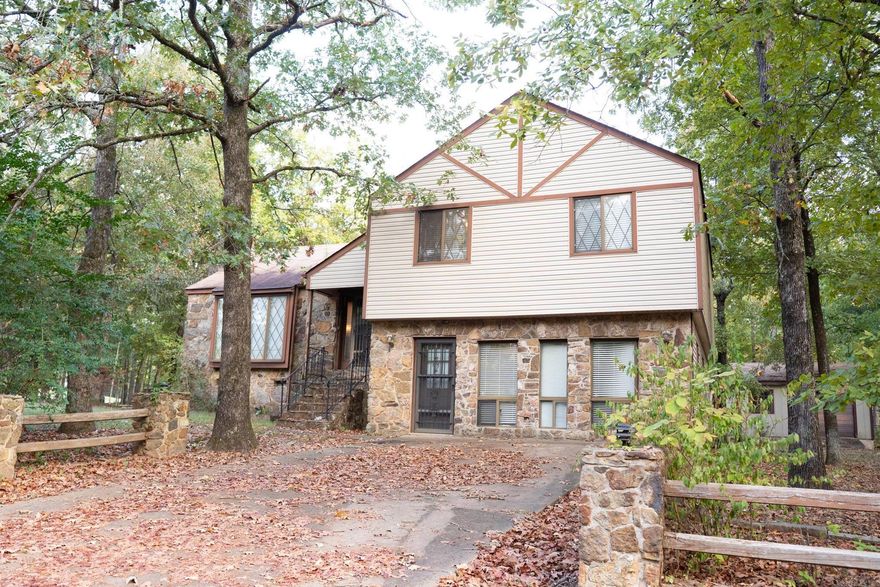 This lovely home on the 13th hole of the Indian Hills golf course is surrounded by beautiful trees in the Castle Ridge Heights neighborhood of Fairfield Bay. It offers plenty of space with three bedrooms, two bathrooms, spacious den, vaulted ceiling, and a gorgeous stone fireplace that creates a cozy atmosphere. The large garage provides great storage options, and the yard features charming stone rockwork for an inviting feel. With a little TLC, this home could truly shine—don’t miss out!