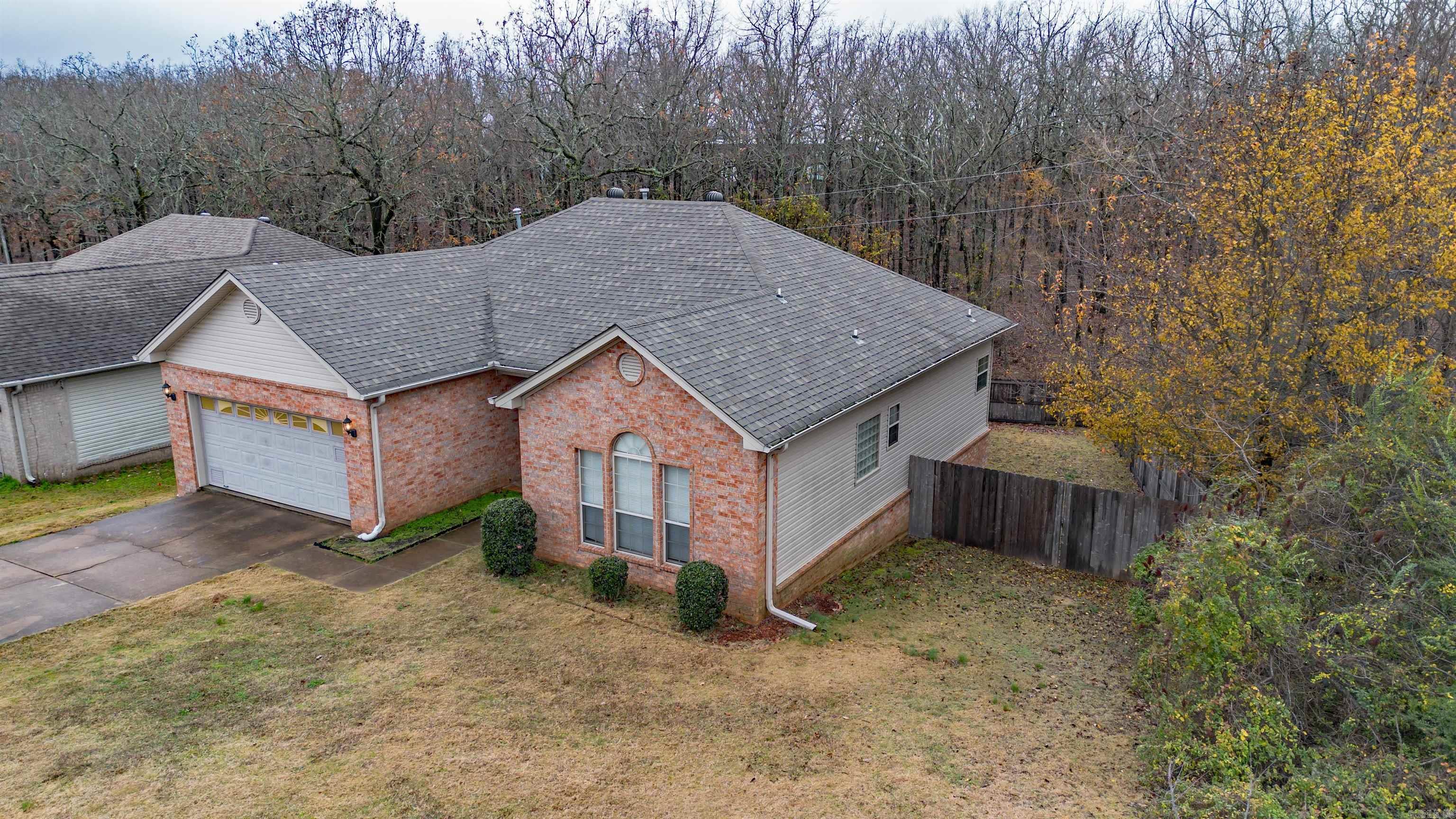 This remarkable all-brick home will give you a great sense of comfort and privacy! The home has 3 bedrooms and 2 bathrooms. The split floorplan is ideal for families or having a great guest space! The open floorplan throughout the kitchen, dining and living room is absolutely awesome! The kitchen is bright with tons of cabinet space and storage! You will be captivated by the serene, wooded view when you step onto the back porch. Just think of the quiet mornings or evening sunsets you can enjoy in peace & tranquility. This home has a fully fenced backyard. This home is the total package and it comes with a one year home warranty with First American!