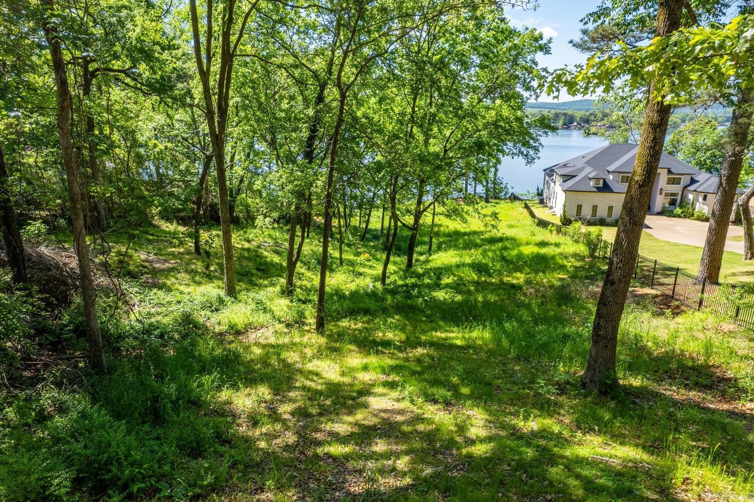Big lake views and a whopping 145' of lake frontage. Build your dream home on the shores of beautiful Lake Hamilton. Close to Garvan Gardens your summer never smelled so sweet! Grab your plans and pack your dreams, it's to get building!