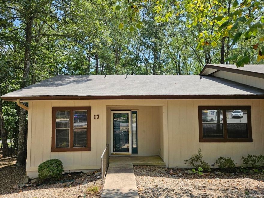 NEW ROOF WAS INSTALLED IN AUGUST 2024! This one level townhome located in the quiet La Coruna Courts in beautiful Hot Springs Village is ready for a new owner. When you walk through the front door, you will fall in love with this adorable end unit townhome. Conveniently close to golf courses, walking trails, churches, gas stations, banks, restaurants, pharmacies, grocery stores, and the West Gate, this is the perfect location. With 2 beds, 1.5 baths and numerous updates, it is sure to meet all your needs as a primary residence or investment property.   Some of the updates include NEW light fixtures, ceiling fans, new paint, laminate flooring, sinks, faucets, toilets, exposed shelving, and ALL NEW stainless steel kitchen appliances. Outside you will find beautiful landscaping and a large back deck with two retractable awnings. This property is MOVE-IN READY! Call or text today to schedule your private showing!