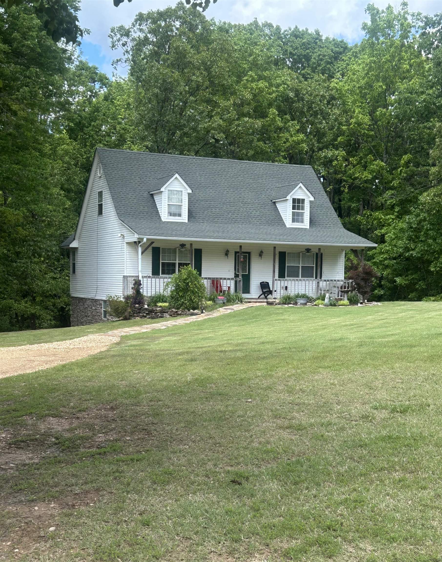 Escape to this serene country retreat, nestled on 7.22 +/- acres of beautiful wooded landāperfect for outdoor enthusiasts who love hunting or need space for a shop building. Enjoy your morning coffee from the back deck, taking in the peaceful forest views, or unwind on the large front porch, rocking in the swing. Ideal for both outdoor living and entertaining, this property provides the best of both worlds. Currently operating as a successful Airbnb, this home offers excellent income potential. With three levels of spacious living, thereās plenty of room for family, friends, and guests. The finished basement includes an entertainment room, two additional bedrooms, and a full bathroom, making it an ideal space for visitors or extended family. Upstairs, youāll find two cozy bedrooms, with the master conveniently located on the main level. The property also features a workshop with an attached apartment, complete with a kitchen, living room, bedroom, and laundry areaāperfect for guests, in-laws, or even as a rental unit. This unique home truly offers endless possibilities. Schedule a showing today to experience this extraordinary property firsthand!