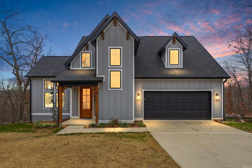 Welcome home! This stunning modern 4-bedroom, 2.5-bath two-story home offers soaring vaulted, beamed ceilings and a bright, open layout ideal for gatherings accented by a gas fireplace. The kitchen features quartz countertops, custom tile, a gas range, and a refrigerator that stays for easy move-in. Enjoy smart conveniences like two washer/dryer connections (One in Primary Closet, One upstairs), double vanities in both full baths, a spacious primary suite with a huge walk-in closet, and an upstairs bonus room for an office or playroom. Step outside to a large private deck overlooking a large, tree-filled backyard with beautiful views and custom fire pit. Located just two minutes from Loch Lomond Lake, golf, clubhouses, fitness center, pickleball courts, and bike trails, this impeccably maintained home delivers the Bella Vista lifestyle! Other thoughtful upgrades include French drains, gutter guards, garage shelving, and double 100lb propane tanks for extended use between refills! Schedule your showing today!