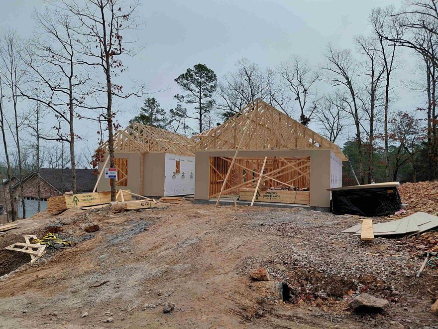 What a view on the 10th fairway of Hot Springs Village's desirable Ponce course. Deaton's popular Peppercorn plan was made for todays modern lifestyle. Gourmet Kitchen with large center island, gas cooktop with custom range hood, built in oven and microwave and oversized walk-in pantry. All with views of the living and dining space, two back covered porches and an outdoor fireplace will make you never want to leave! As always 9 and 10 ft. ceilings, custom maple cabinetry in the kitchen and all bathrooms, luxury vinyl floors throughout. Both full baths have custom tile showers and the primary includes a freestanding tub. The Primary suite closet connects to the utility room which connects to the mud room which makes this home not only beautiful but super functional. The oversized garage will give you extra storage space and the  flat driveway will allow you to enjoy your home for years to come  Don't wait to long, there is still a little time to make a few choices and personalize the interior to your taste. Expected Completion May 2026
