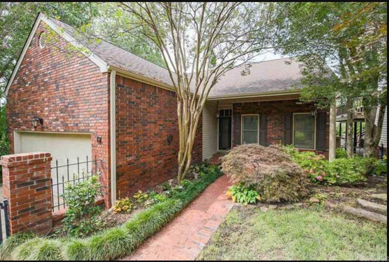 This home, at the end of a quiet street, offers privacy and tranquility. It features a two-car garage, side parking, and a charming front courtyard with an antique iron and brick fence. A covered porch invites relaxation. Inside, the foyer has 9½-foot ceilings and new hardwood floors. This newly remodeled home features open layout and is filled with natural light, perfect for entertaining. The Chefās Kitchen includes a 6-burner gas cooktop, double oven, granite countertops, island, and breakfast bar. The main level has a large living area with a dry bar, bar fridge, floor-to-ceiling windows, and a fireplace. The guest suite offers a walk-in closet and en-suite bathroom. The primary suite includes 3 closets and a spa-like bathroom with a double-sink vanity, soaking tub, and custom walk-in shower. Upstairs, find a large bedroom, full bath, laundry room w/sink, and attic storage. The lower level has a flexible space for a third bedroom, den, or in-law suite with a full bath and private patio. A 250-square-foot wine cellar is also included though it is not part of the total square footage. Double decks overlook green space, ideal for outdoor living and privacy.