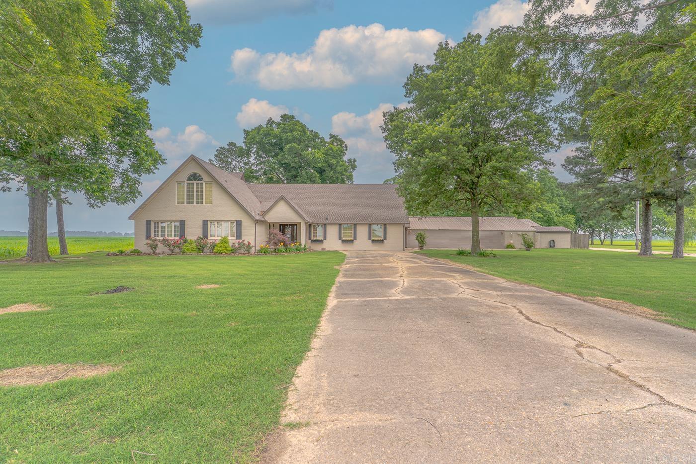 Spectacular home with ALL the room to grow!|6 Bed | 5 bath| Over 7000 SF |5 acres. Welcome to the best of both worlds-country living and a paved county road, on a beautiful piece of land boasting productive pecan trees, just within a couple minutes of Paragould amenities! You will fall in love with the possibilities of the space provided in 6 large bedrooms (4 down, 2 up), 5 baths, and several living spaces, as well as the individual features, such as built-in shelving and beams throughout the home, and huge, custom-built master closet, that really make this house a home. You will find endless areas to entertain guests, including an enormous den with pecky cypress walls and beams and a large brick, gas fireplace, with doors that lead to the pebbled patio out back. The custom kitchen is endowed with cabinet covered sub-zero fridge and freezer, double wall oven, 2 dishwashers, separate ice maker, farm sink and a 11'x5.5' island with and 6 burner stove top with griddle and pot-filler. Never run out of storage space, as there are several storage areas, including an over-sized pantry with plenty of cabinet and counter space, a generous-sized laundry room, and shop-converted garage with
