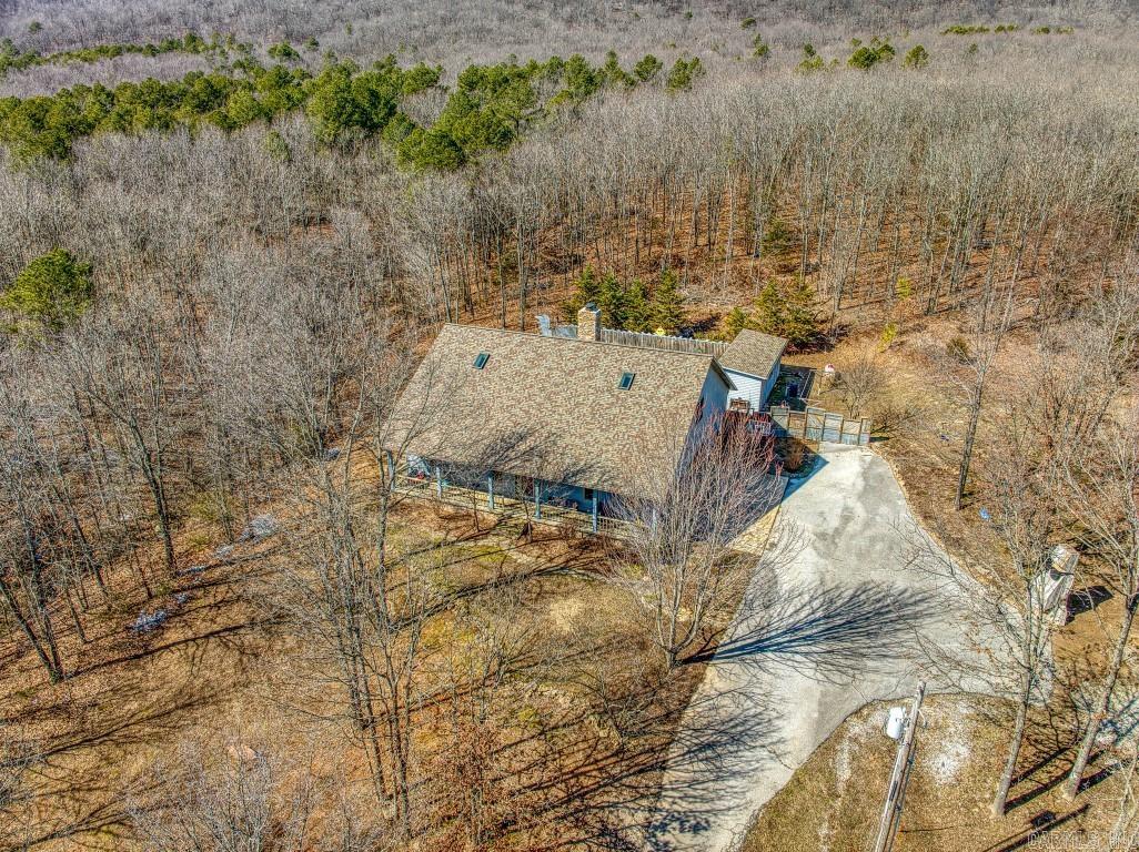 Stunning Property! Located at 6122 Scenic Valley Drive; Harrison, AR - This property boasts of 30 wooded private acres with Terrapin Creek running through it, 3 bedroom, 3 full bath, 1/2 bath, plus cozy sunroom off of the primary bathroom, office with access to the unfinished basement, attached oversized 2 car garage. This home is a lovely, peaceful retreat and plenty of space to entertain from the cathedral ceiling in the living room with wood burning fireplace insert to the spacious kitchen, dining, to the screened in porch with wood burning fireplace, leading out onto the heated in-ground pool with wrap around sun deck, with firepit ready for you to roast smores Perfect for family gathering! Outbuilding for the pool equipment, plus an additional detached barn/workshop. Abundant wildlife! Attic storage located in the main hall & both upstairs bedroom closets. A truly remarkable opportunity for these seeking a peaceful and luxurious retreat. Buffalo River just 30 minutes away & 45 minutes to Branson MO