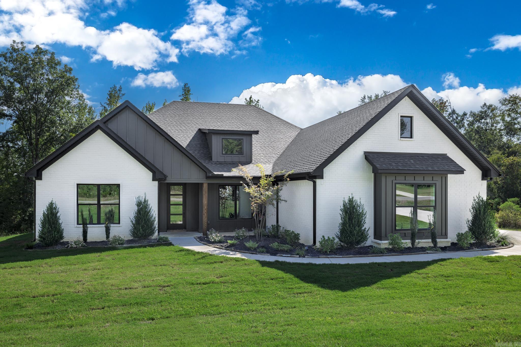 This stunning new construction home in the beautiful North Ridge Estate, just outside of Arkadelphia, offers the perfect blend of style and function. Featuring four spacious bedrooms and three bathrooms, this home boasts an open-concept living, kitchen, and dining area designed for entertaining and everyday living. The kitchen offers tons of counter space, a massive walk-in pantry, and a layout that makes meal prep effortless. The luxurious primary suite includes a large soaking tub, oversized shower, and separate his-and-hers walk-in closets. The guest bedrooms are connected by a convenient Jack-and-Jill bath, providing both privacy and practicality. Outside, youāll find extra landscaping that enhances curb appeal and a back porch with a cozy fireplace, ideal for relaxing evenings. Sitting on over an acre, this property provides plenty of space and a peaceful setting to call home.