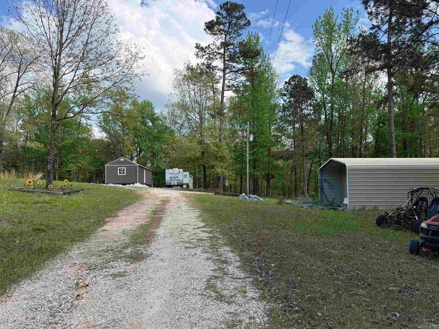 This peaceful, quiet, 4.25 acres is located minutes from Lake DeGray and is great for a weekend getaway or a permanent residence. There is a 14 X 40 (2025) tiny home that is under construction and ready to be completed, a 16 X 35 metal building (2024) with some interior features added and a carport/storage building (2022) on it. Outside the fenced yard there is a fishing pond on the back of the property.  It offers plenty of room for the kids to roam and play and also room to store those lake toys! The solar powered gate for easy access and, and it all sits off a well-maintained county road. Schedule a showing today! See agent remarks.