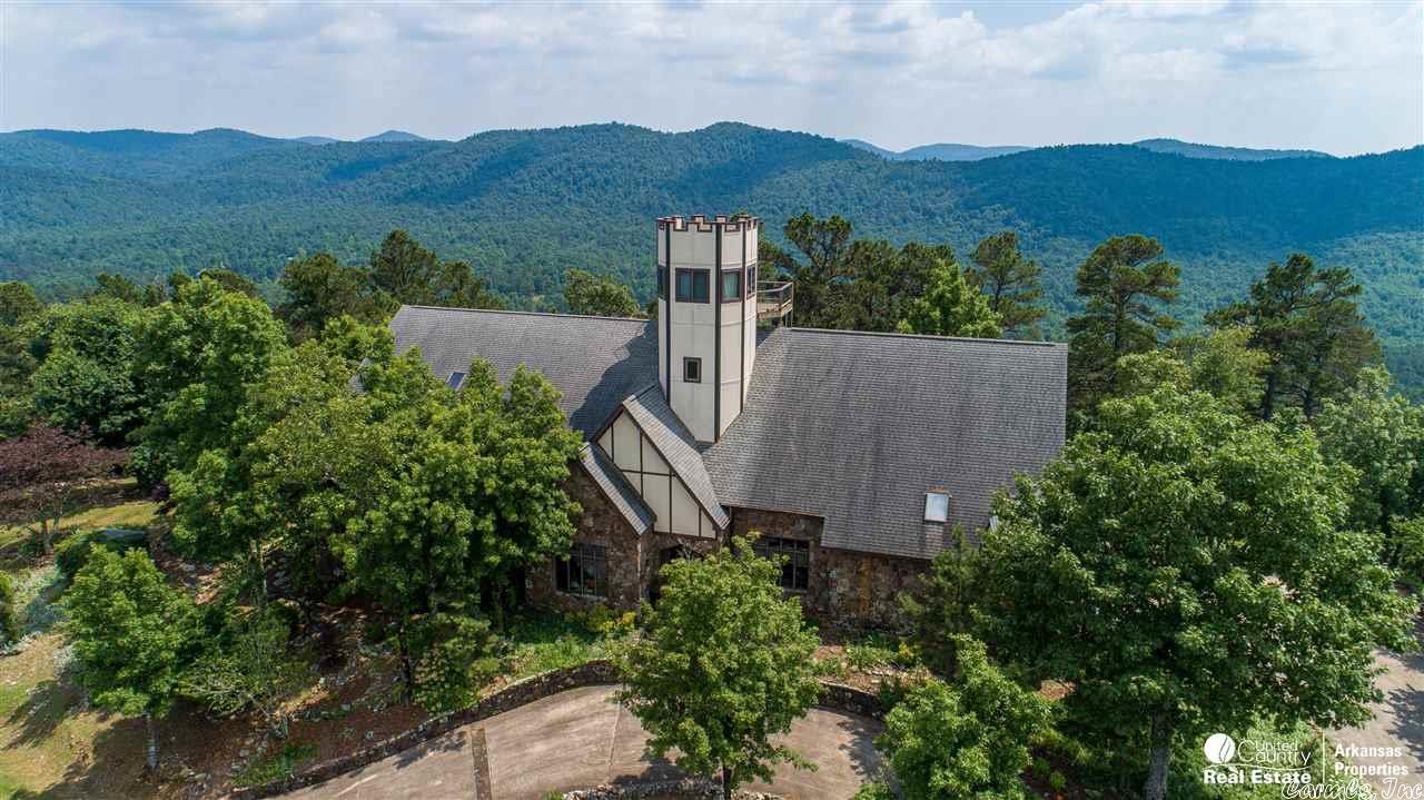Castle on a Mountain for sale! Now is your chance to own a luxury castle on a mountaintop! Located in the Ouachita National Forest with views as far as they eye can see in all directions! The 6800+ square foot multi-story home has 6 bedrooms, 6 and a half baths, gourmet luxury kitchen, wood burning fireplace in the living room, formal dinning room, and a 50+ feet high observation tower with deck! The house has a two car attached garage, carport and wine cellar. Gas, Oil and Mineral rights reserved.