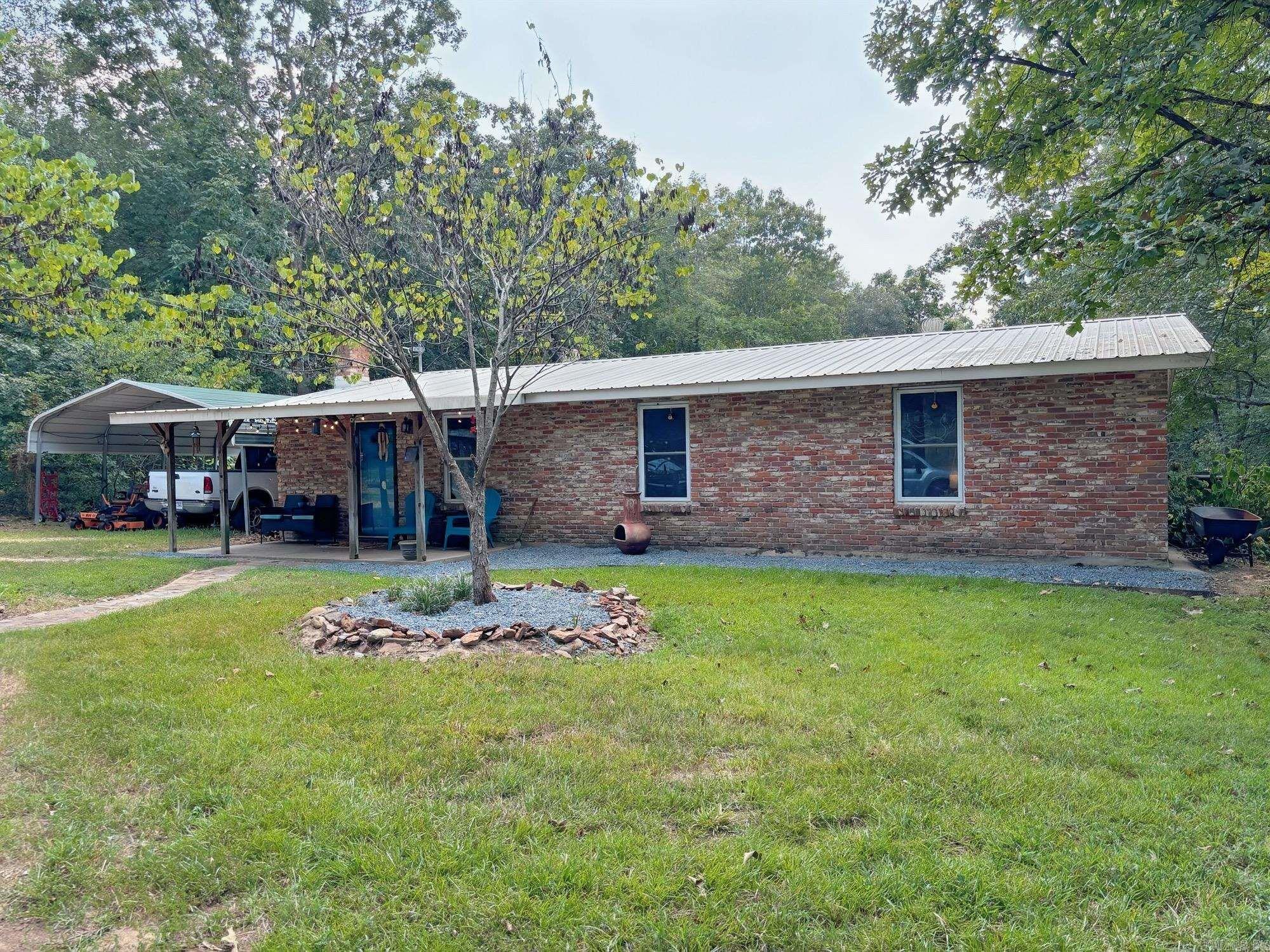Home on over 14 acres in Genoa ISD! Private location, less than 2 miles to Genoa schools. Heavily wooded with pond near back of property. Workshop with electricity, storage building, carport, covered patio and smokehouse room. This homesite gives all the rustic vibes with updates inside including windows, updated flooring, light fixtures and cabinets. Don't miss out on this one!