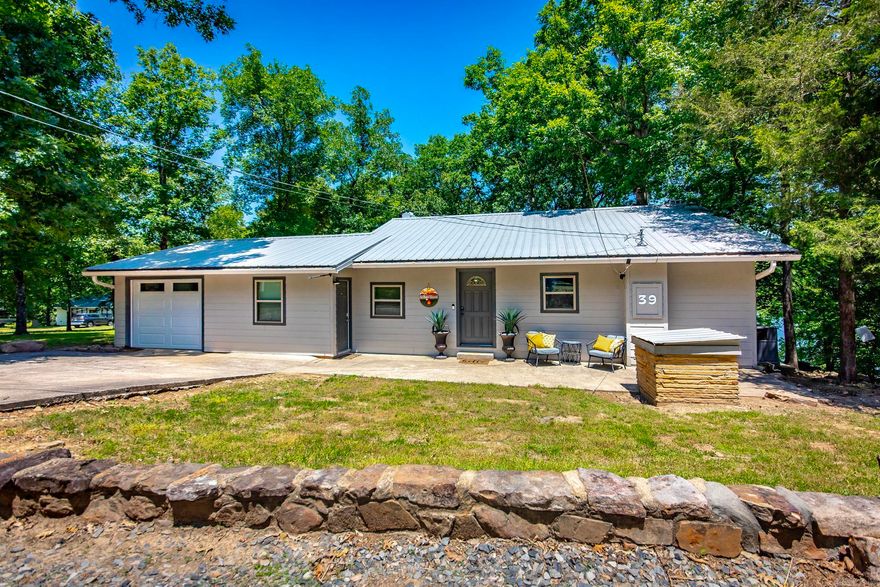 Escape to lakefront living on beautiful Greers Ferry Lake! This charming 3-bedroom, 2-bath home offers the perfect blend of comfort, relaxation, and entertainment. Ideal for hosting family and friends or simply unwinding while overlooking the water. Don't forget the boat slip, that comes with this awesome property. Inside, you’ll find a spacious layout with plenty of natural light and room to gather. The bonus room/man cave provides the perfect space for game nights, hobbies, a home theater, or additional guest accommodations. Whether you’re looking for a full-time residence, weekend getaway, or vacation investment, this lakefront property delivers the ultimate Greers Ferry lifestyle with direct access to peaceful waterfront living. Some pictures were taken below the white line. SQFT includes downstair and bonus room, sqft measuring is encourage. Some photos and video are AI enhanced. Agents see REMARKS.