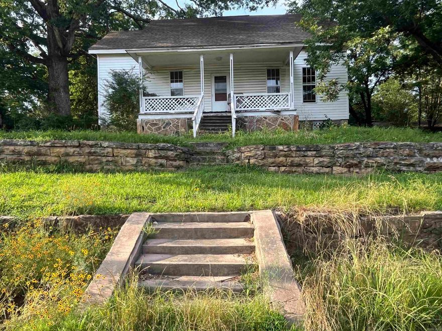 Investors or project seekers! Two-Story home with previous fire damage, second story has been added. There is a small kitchen that has been gutted and is incomplete, there are 3 bedrooms downstairs and a primary bedroom with primary bathroom on the upper level. This property has a front porch facing south as well as sidewalk and steps that lead to the street with a double rock wall. West side of property has a large oak tree on the property; there is also a pecan tree on property. The shared driveway is on the eastside of property and owner states is shared with 302 W Church St property. There is a detached carport on back of property as well as 2 back entrances to the home. Property has no utilities on at this time property is being Sold AS IS homeowner will not make any repairs. See Agent Remarks.