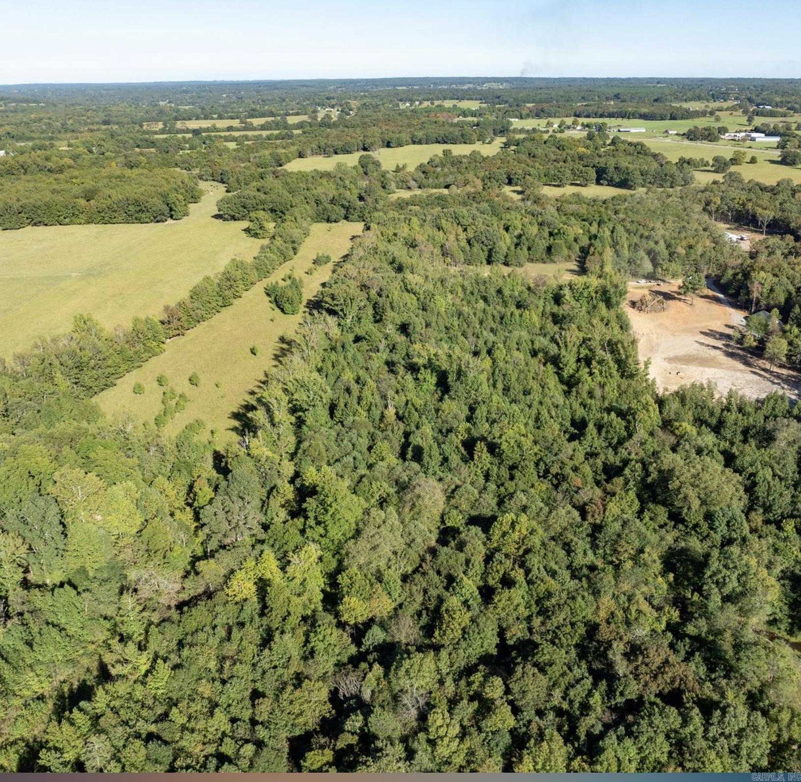 Hurry and see this beautiful large wooded tract that is bordered on the west side by Mill Creek and fenced on the back and east side. Approximately 3 acres has been cleared and just waiting for your dream home or beautiful cabin on this private sanctuary. You are within minutes to Quitman and to Greers Ferry Lake. Power and Water are at the road. Call today for more information.