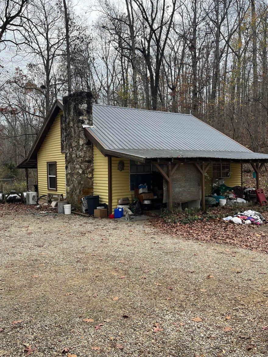 Own your piece of the Ozarks.  This 1, possibly 2 bedroom home is ready for its new owners.  Small creek runs next to property.  Newer metal roof and mini split.  Solid older house with lots up potential.  Amenities of Ozark Acres at your convenience.  Outbuild for storage has electric ran to it.  Approximately 1100 sq foot of heated and cooled living space.