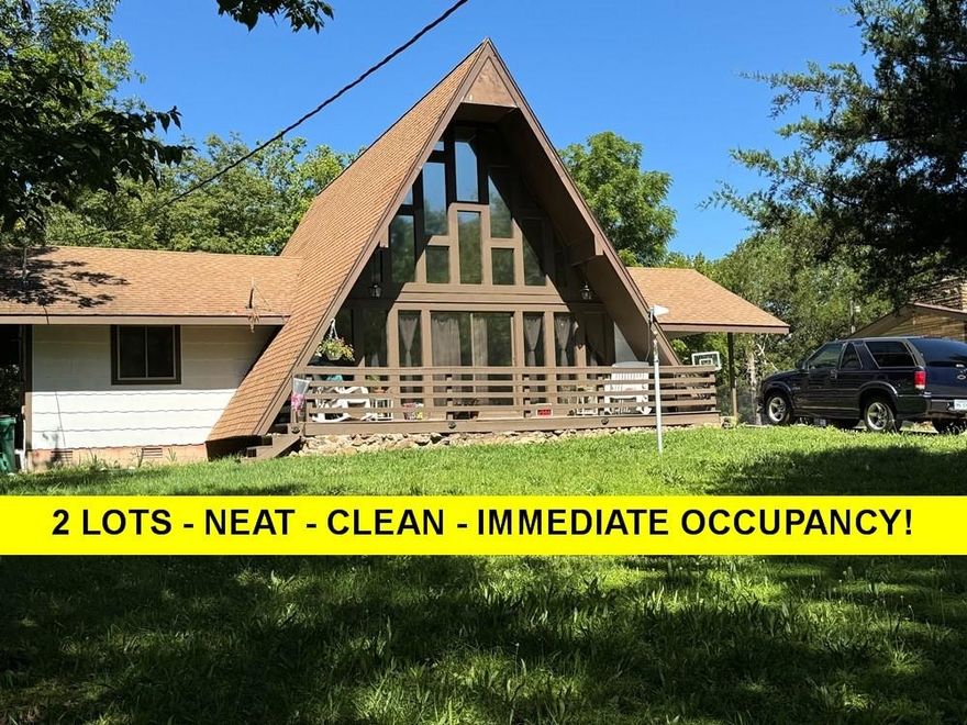 Neat and Clean WONDERFUL 3 bed 1 1/2 bath just $129,900 on TWO LOTS- IMMEDIATE OCCUPANCY!! BRAND NEW ARCH ROOF being installed or buyer can receive credit in same amount... Great A-frame home, close to the lake, approx. 1236 sq. ft. (per arcounty data) New septic approx. 2 yrs. ago. New heat and air last Oct per owner.  New 40 gal water heater per owner 7-24. Roomy kitchen-dining- includes all appliances even washer & dryer which is hidden behind cool barn door. White cabinets, extra big white kitchen sink. High ceiling in living room, 2 bedrooms on main level with 1 full bath down-new vanity and HEATED FLOOR! Lots of closets. Lots of vinyl windows... Upstairs is loft-could be used as 3rd bedroom does have closet and 1/2 bath. Brand new carpet in upstairs bedroom and on stairs. Attached carport with 2 storage closets. Nice deck off living room. Great relaxing space in yard with firepit. Lot next door offers all kinds of possibilities! Listing #2383