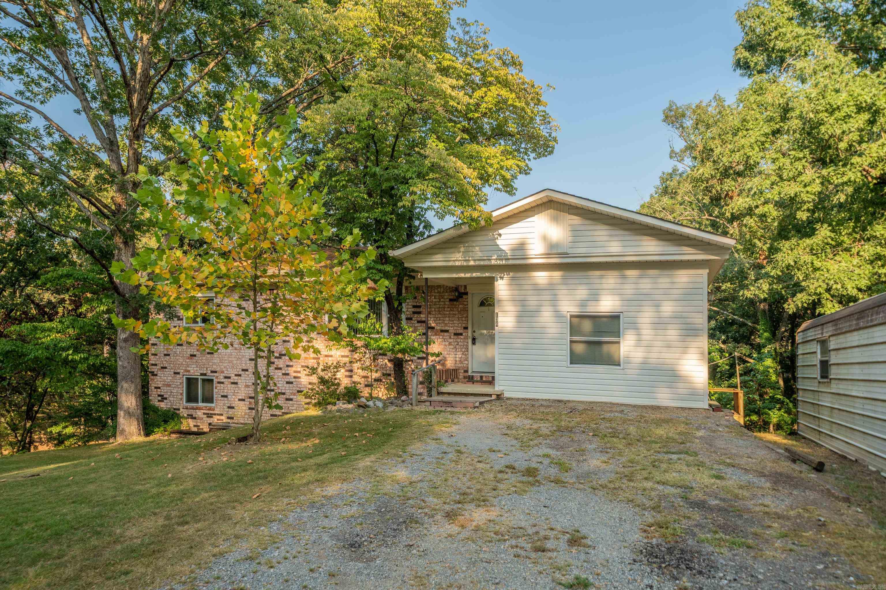 Spacious 3-Bedroom Home in Lake Hamilton School District! This inviting 3-bedroom, 2.5-bath home offers an impressive amount of living space, including two living areas, two versatile bonus rooms, and finished basement. The laundry room features a convenient sink, and two-car carport includes extra storage in the back. Situated on a little over half an acre on a desirable corner lot, the property boasts mature landscaping with a beautiful Magnolia tree and a Peach tree. Enjoy outdoor living on the large deck. Located just about a mile from Walmart, restaurants, and other conveniences, and in the highly sought-after Lake Hamilton School District, this home combines space, comfort, and connivence. Don't miss this great value for the square footage--schedule your showing today!