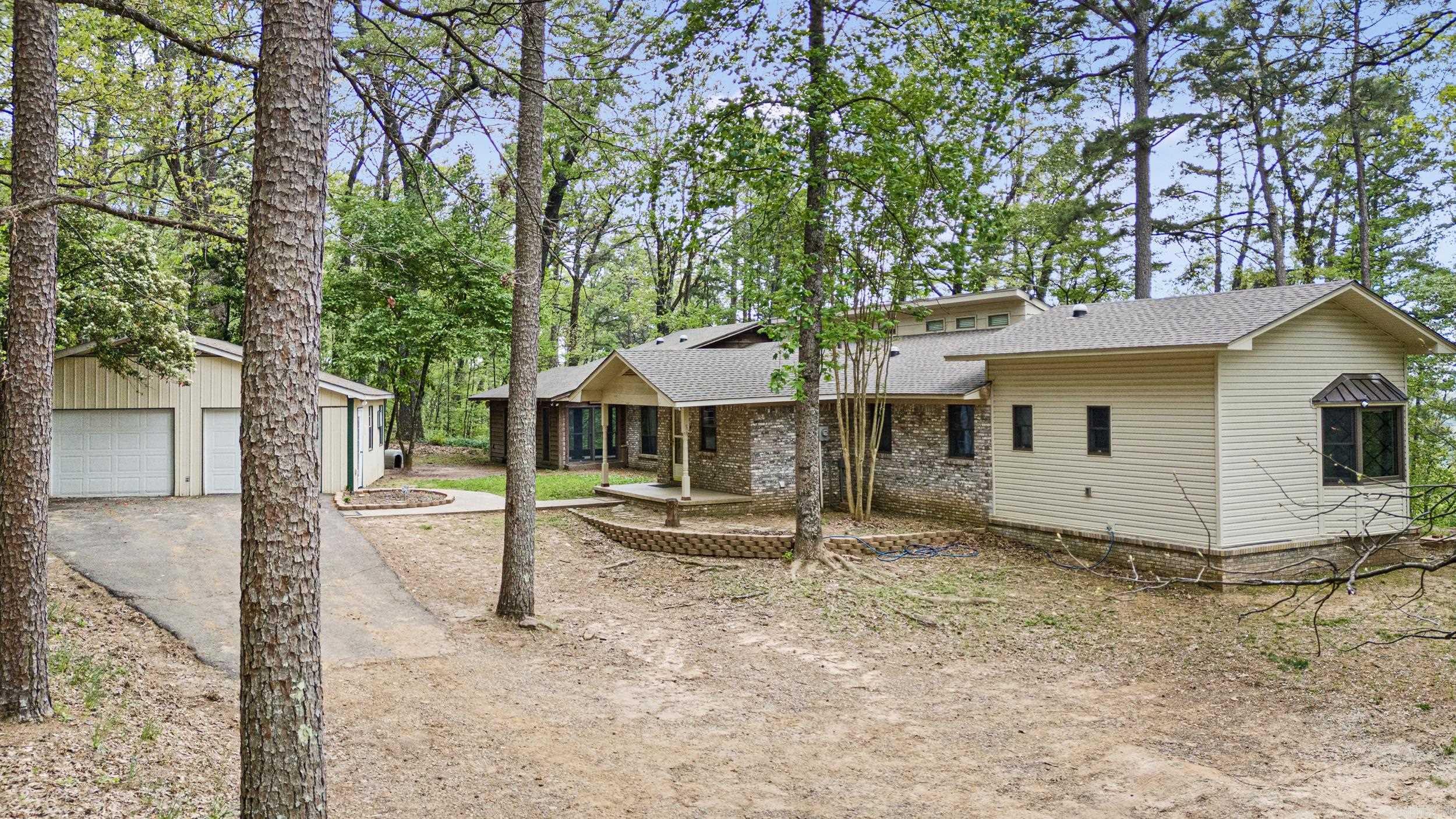 Nature Lover’s Retreat – Private Homestead Minutes from Town Tucked away on a secluded country road just minutes from town, this one-of-a-kind rural sanctuary is a dream come true for nature lovers, homesteaders, and anyone seeking serenity. Thoughtfully designed with a smoky, moody aesthetic, this near self-sufficient home offers the perfect blend of modern comforts and off-grid living. Enjoy ultimate privacy and security with your own private hunting grounds, two private wells connected to a holding tank with whole-house water filtration, and a reliable backup generator. Eco-conscious features include radiant heated marble floors, tankless water heater, energy-saving solar daylight tubes, and an efficient whole-house fan—perfect for reducing your carbon footprint while staying cozy and comfortable. Adventure awaits just minutes away in the breathtaking Ozark National Forest—perfect for hiking, scenic drives, or exploring your own slice of wilderness with the Illinois Bayou just a short hike from your door.