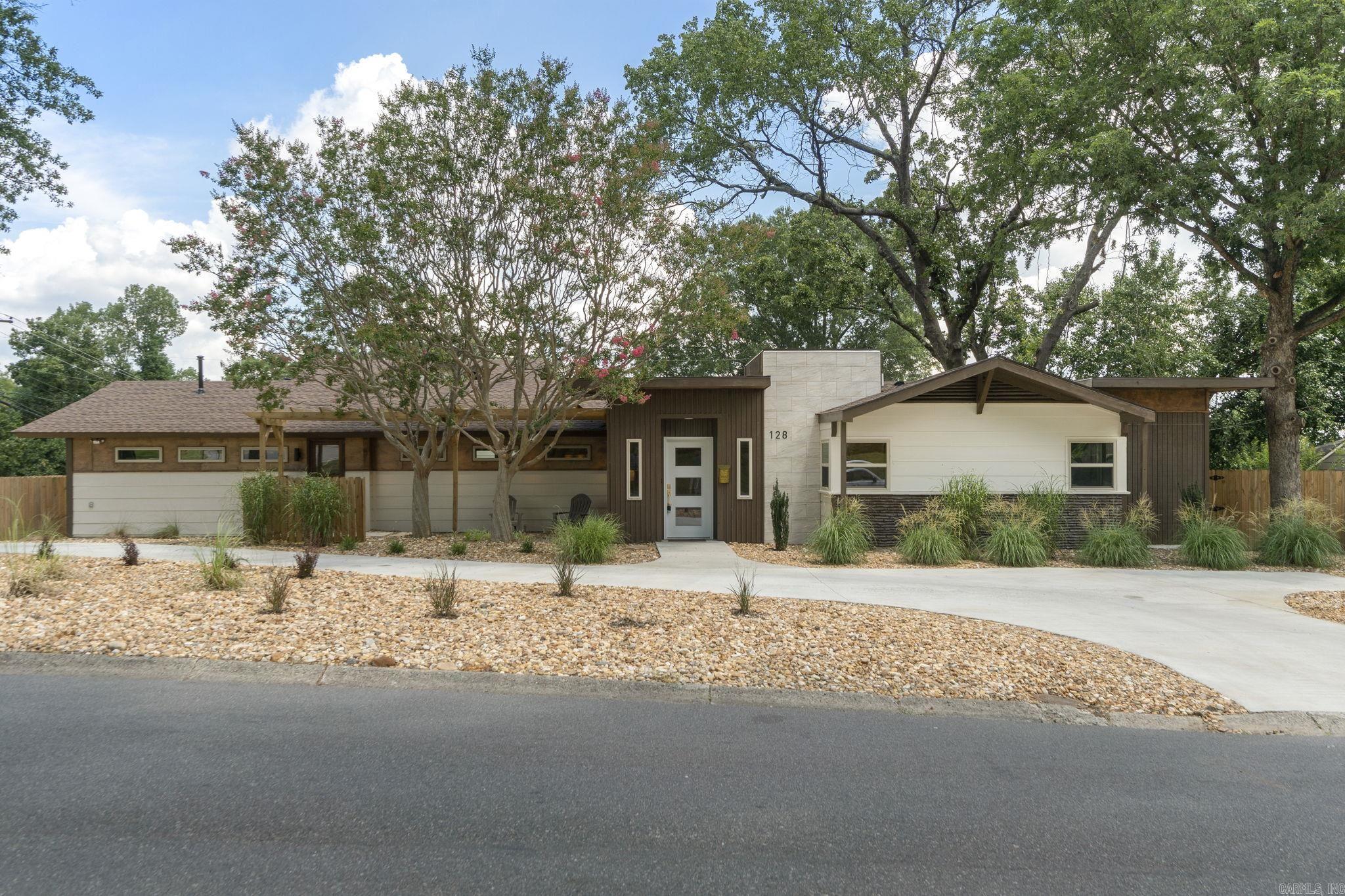 Completely remodeled 2,312sq ft main house and 643sq ft guest house, located just minutes away from the Heights, Cammack and Cantrell Road. Guest house offers larger accommodations or rental/Airbnb potential. This home features custom touches like terrazzo-style porcelain tile and exposed original cypress ceiling beams — it is a perfect blend of classic style with modern touches. Inside the main house, you'll find an open-concept living/dining area, oversized laundry room and stylish wet bar, perfect for hosting or relaxing. The kitchen features sleek finishes like European style cabinetry, gas stove, stainless steel appliances and plenty of counter space! Refinished hardwood and tile floors give the entire home added character and charm. Enjoy working from home in your spacious, front facing office with a private entrance. Above the 2 car garage is a separate living space from the main house and includes 1 bedroom, 1 bathroom, a full kitchen, a stackable washer and dryer, and a private entrance — New roof, plumbing, electric, HVAC, windows, etc. Enjoy the privacy fenced backyard, new spacious deck and yard with mature trees.........this home is waiting for you!