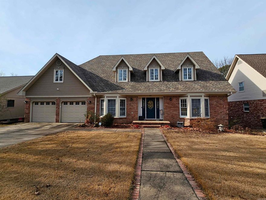 Welcome to Overbrook Subdivision. This well-designed home offers 5 bedrooms, 3 full baths, and 2 half baths with space for work, play, and relaxation. The main level features oak wood flooring, an office, formal dining room, updated kitchen, and a great room centered around a gas log fireplace. The primary suite is conveniently located on the main floor with a walk-in closet and en-suite that includes a double vanity, soaking tub, separate shower.  Upstairs you’ll find three bedrooms, one and a half bathrooms, and a large walk-in attic that could easily be finished out for added living space. The lower level includes a bedroom, den and a full bath. This bedroom is currently being used as a game room.  There is also a workshop (this is a handyman's dream).  Outdoor living is enhanced with a covered porch on the main level and a deck on the bottom level, overlooking a private backyard surrounded by mature trees. Updates include an architectural shingle roof approximately six years old and HVAC units replaced in 2023 and 2014.  This home is perfect for a large family.  There is plenty of room to spread out.  Call today for your private tour.