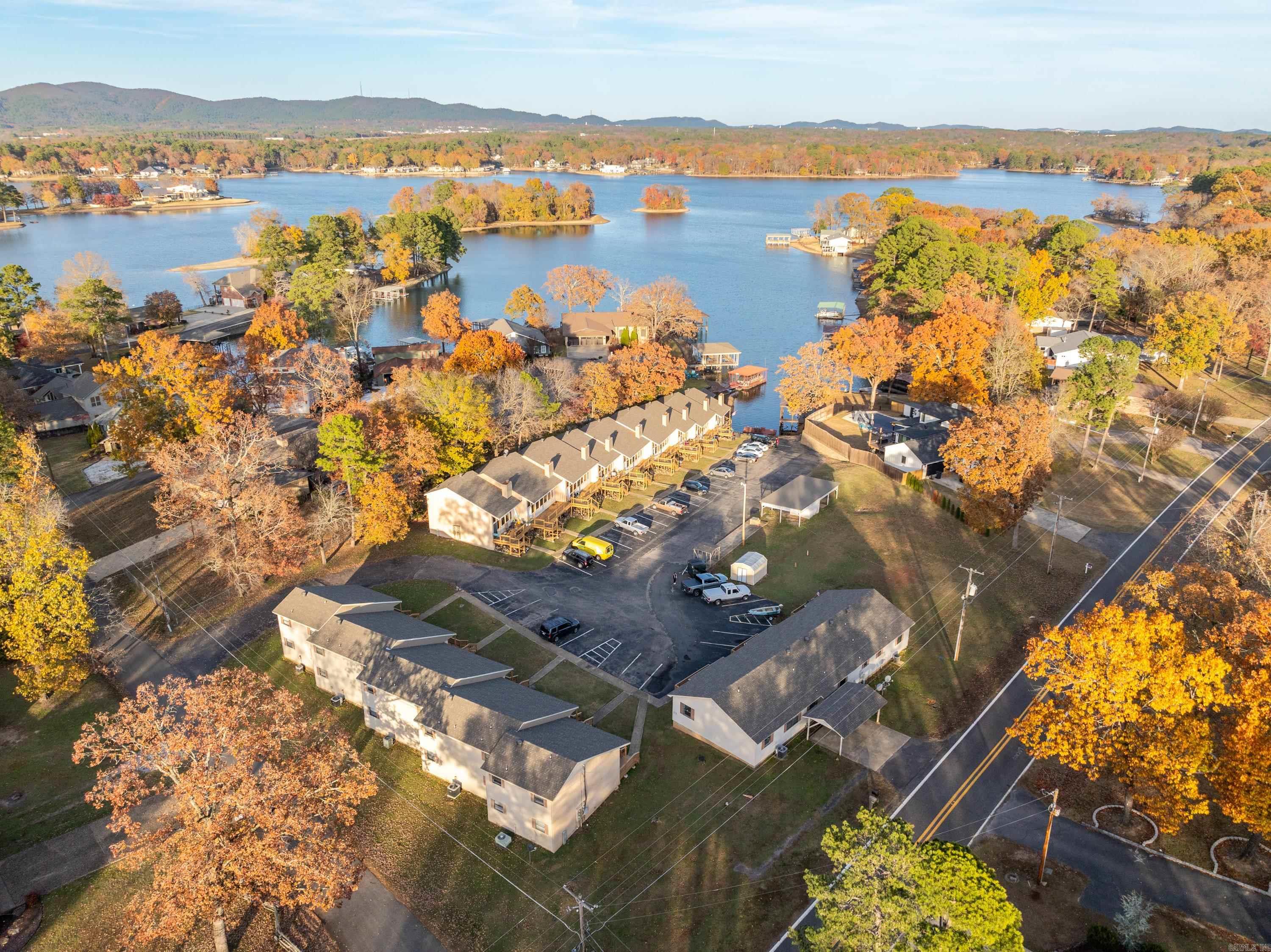 Discover an incredible investment opportunity with this 17-unit multi- family condominium complex, located on the shores of Lake Hamilton in Hot Springs, Arkansas. Boasting a market net operating income (NOI) of $195,738, this property promises solid returns and exciting growth potential. This lakefront complex is not only a secure income-generating asset but also a unique opportunity for further development in a highly desirable location. A designated area within the lot is ready for the construction of up to 7 additional 3-bedroom,2-bathroom units, providing an opportunity to increase revenue and enhance the property’s value.
