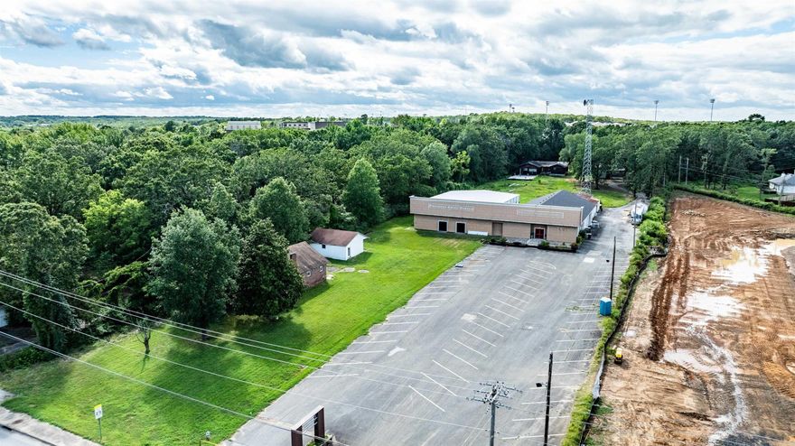 Commercial property featuring 200 ft of highway frontage, a huge exterior sign, two interconnected buildings totalling 10,000sq/ft with versatile moveable walls, multiple restrooms, a kitchen, a 14 ft roll-up bay door & 7 exit doors, outside storage, paved parking for over 50 vehicles on more than 4 acres of land. Property Also features three houses, ideal for renovation or teardown. Recently utilized as a church, offering significant multi-purpose potential. Taxes based on county records.