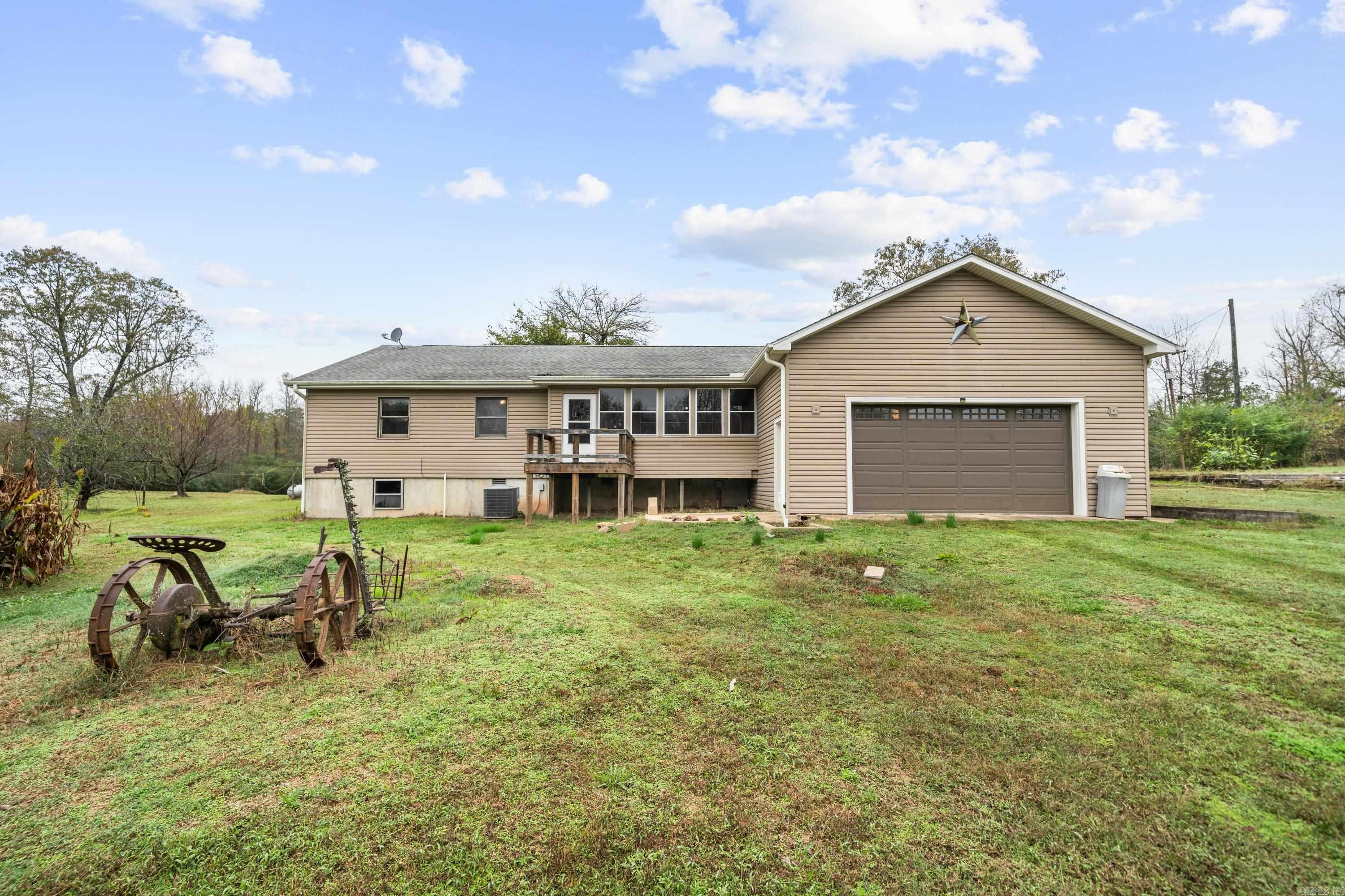 BRAND NEW ROOF - This charming 3BR/2BA home sits on a spacious, cleared 1.5-acre corner lot. Offering 1,700 square feet of well-appointed living space, this residence is a rare find, and it features beautiful 100-year-old hardwood floors repurposed from the historic Mt. Pine Gym. This high quality wood adds a unique story to every step. An oversized laundry area could be converted to another bedroom. The large, screened-in porch provides an ideal space for relaxation, and the perfect place to enjoy your morning coffee. The large, fully fenced, level lot, offers plenty of room for outdoor activities, future landscaping and lots of space for your furry friends to run! There is a small storage building and a pole barn. With a roomy two-car garage and an additional small office, you'll have the flexibility to work from home or create a private study space. Beneath it all, an unfinished 768-square-foot basement awaits, perfect for extra storage or customization to suit your needs. A new roof was installed in 2011, adding peace of mind to this well-maintained property. Don’t miss this blend of charm, space, and opportunity!