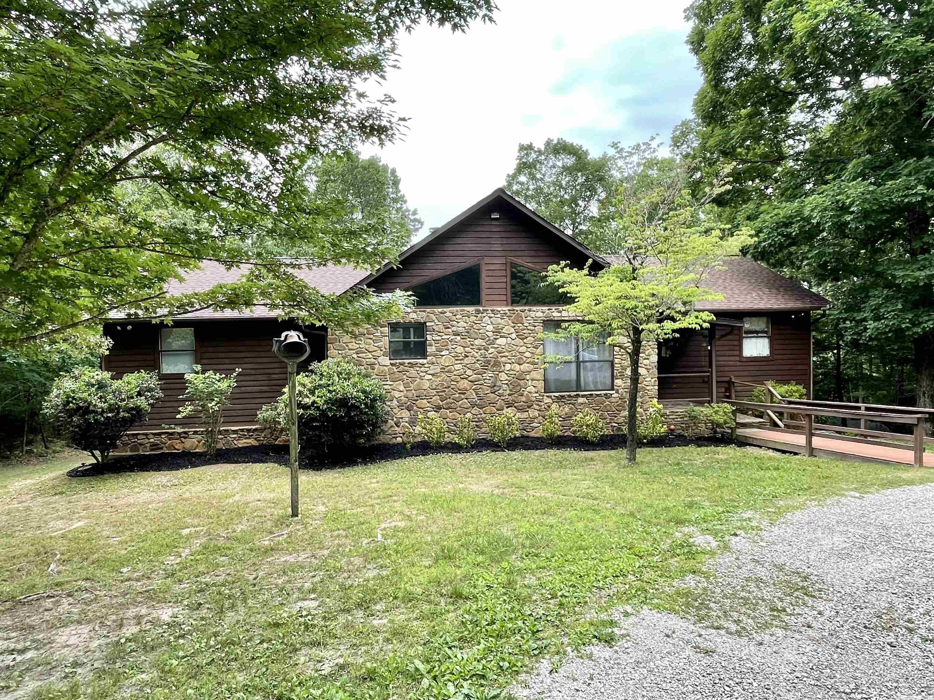 Rustic Style Home and 15 acres in Mountain View!! This beautiful home features 4 bedrooms, 3 bathrooms and a large open living area with vaulted wood ceilings, native stone wood burning fireplace, and an updated kitchen with stainless appliances, granite countertops, & pantry. The Master Suite offers a large bedroom, private deck, full bathroom with laundry room, and walk in closet. Two guest bedrooms and bathroom are separate from the Primary Bedroom. The Basement features a 4th bedroom, craft room, or family room with a full bathroom! The Basement has an awesome wood working shop with lots of storage space along with a garage, making this the ultimate man cave! The back deck features a large screened in porch with vaulted ceilings as well as two open decks. There is a hookup for RV and parking pad. The roof was just installed (2023) The property is all wooded and very private, but close to the Famous White River, creeks, and downtown Mountain View! Call today to view this home!