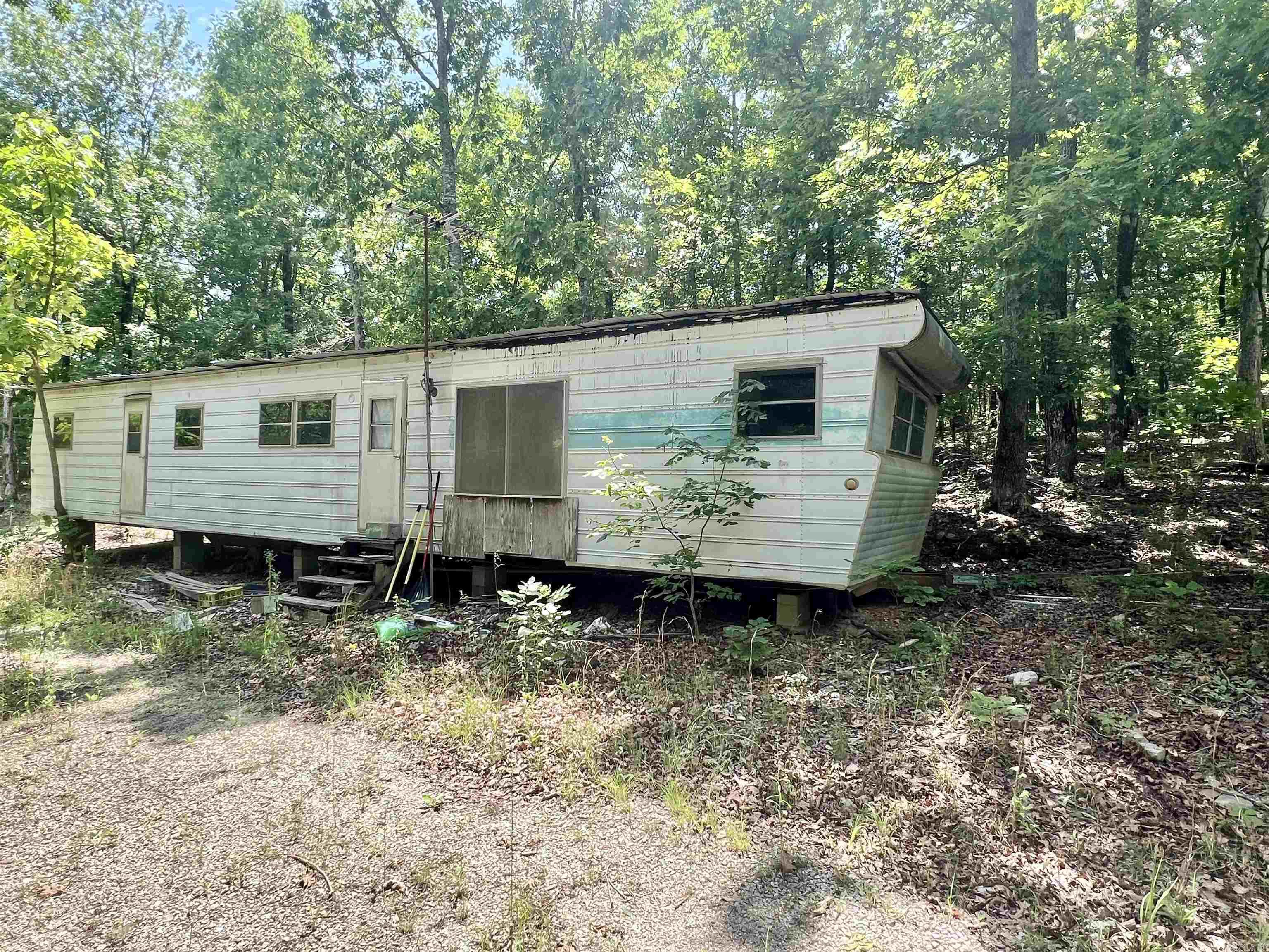 3.01 Acres just a short drive from downtown Mountain View with no restrictions. There is a 520 Sq. Ft. 1-bedroom, 1-bathroom mobile home on the property, it currently needs a little bit of work/clean up, but could be perfect for a first-time home buyer, or even as just a place to stay while visiting the area. The property is connected to public water, and electric, and has a septic tank, ready to go even if you decided to move the trailer and rebuild or put another mobile home or build in its place. Property is being sold as is. Don't miss out on this one, give me a call to set up a showing today!