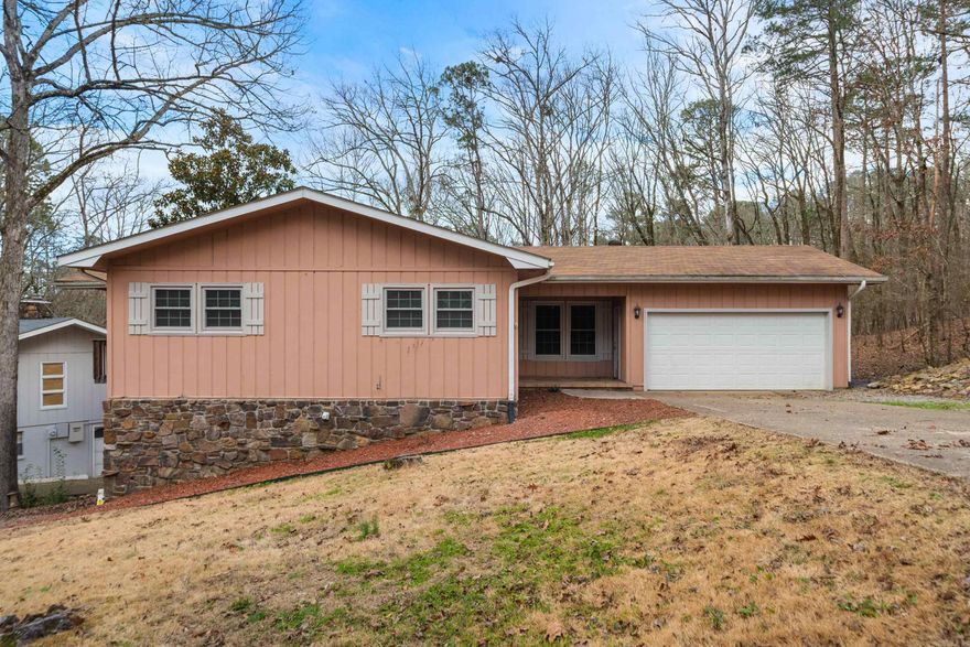 Nestled on a quiet cul-de-sac in Hot Springs Village, just minutes from the DeSoto Beach area, this spacious two-level home offers comfort, flexibility, and privacy. The main level features a generous primary suite with en-suite bath and adjoining home office, a well-appointed kitchen, two additional bedrooms, two full baths, a half bath, and an inviting living area ideal for everyday living and entertaining. The lower level provides excellent versatility with a second living room, an additional bedroom, a half bath, a kitchenette, and abundant storage—perfect for guests, multi-generational living, or a private retreat.